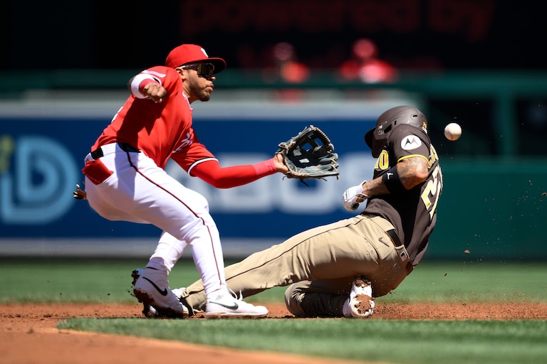 San Diego Padres' Nick Castellanos, right, steals second base against Washington Nationals second baseman Jorbit Vivas, left, during the third inning of a baseball game, Sunday, May 31, 2026, in Washington.