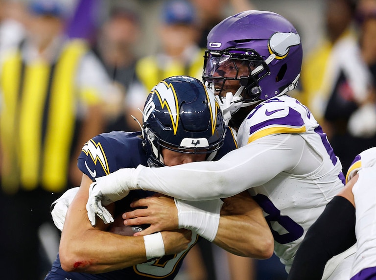 Minnesota Vikings outside linebacker Jonathan Greenard hits Los Angeles Chargers quarterback Justin Herbert in Week 8.