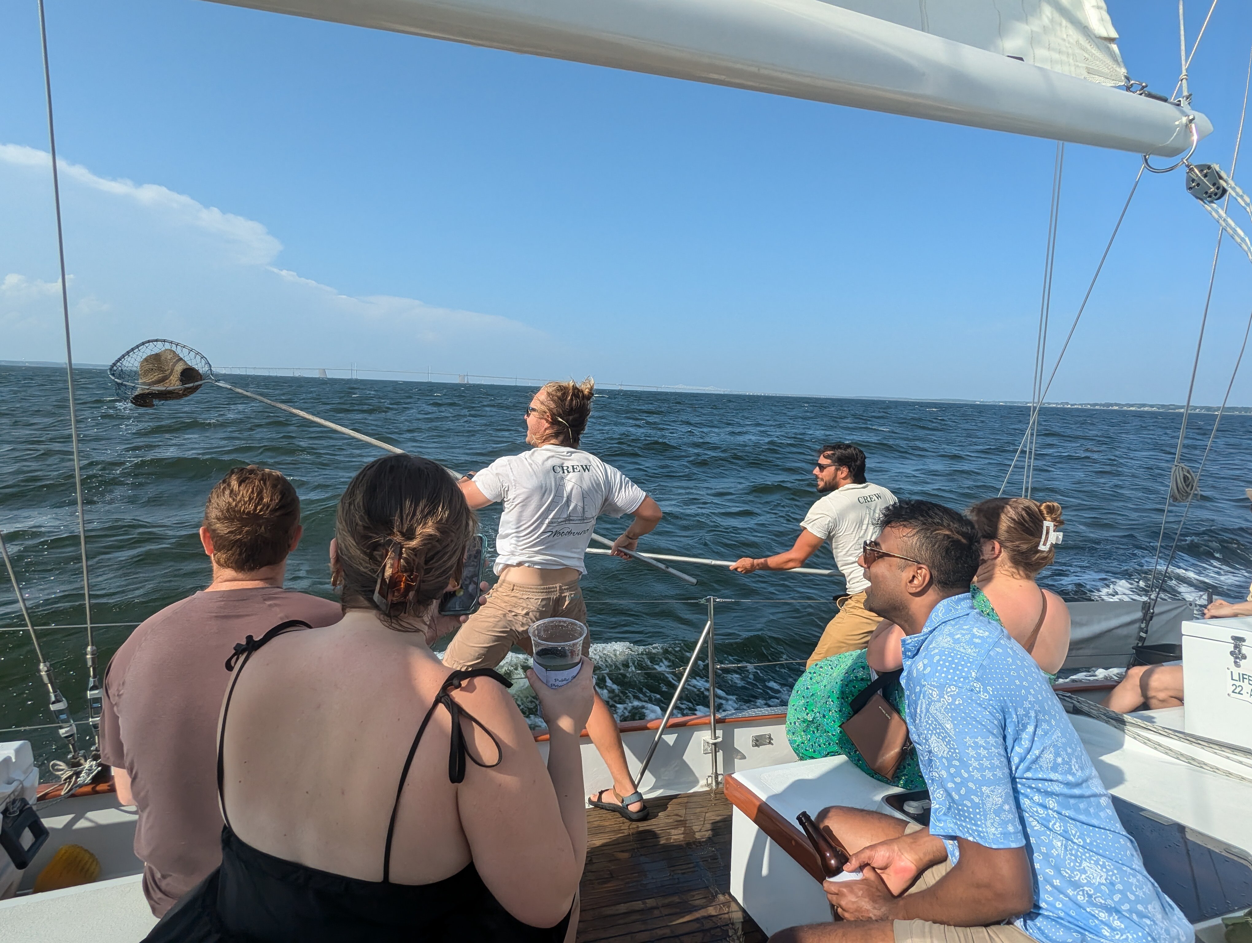 Woodwind II crewmembers Michael Pursell and Andrew Wise and rescue my hat during a sail from Annapolis Saturday with my daughter, lower left, her friends and our family onto the Chesapeake Bay.