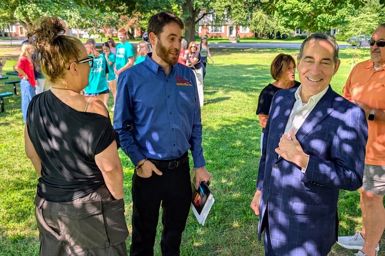 Dan Schwartz, the Democratic candidate for Congress in the 1st District, talks with U.S. Rep. Jamie Raskin and Cambridge United founder Michelle Fowle before a canvass of voters' homes in Easton on July 26, 2026.