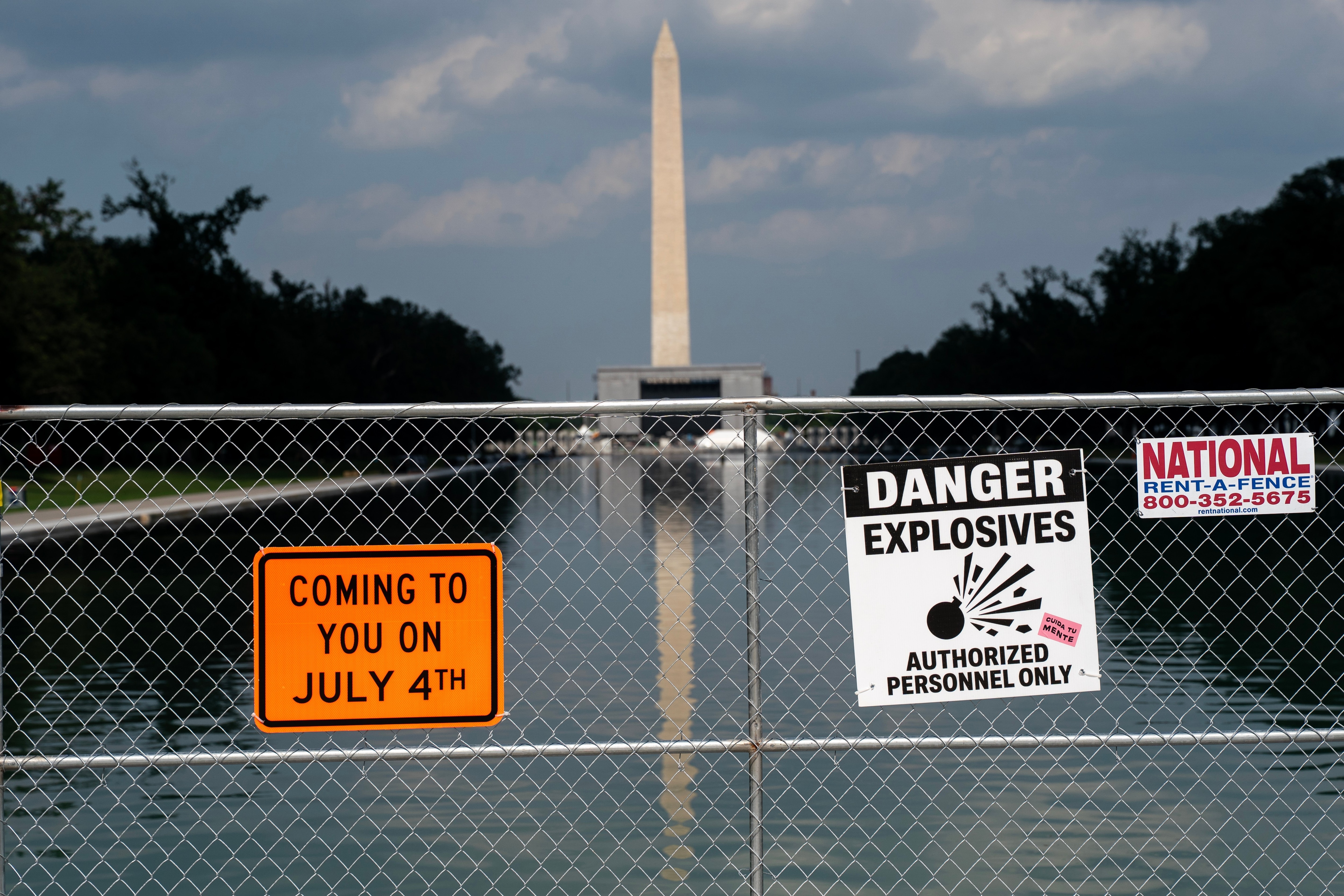Signage and security fencing warns of explosives along the Lincoln Memorial Reflecting Pool ahead of July 4th events on the National Mall, Wednesday, July 1, 2026, in Washington. (AP Photo/Nathan Howard)