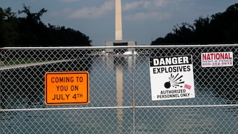 Signage and security fencing warns of explosives along the Lincoln Memorial Reflecting Pool ahead of July 4th events on the National Mall, Wednesday, July 1, 2026, in Washington. (AP Photo/Nathan Howard)
