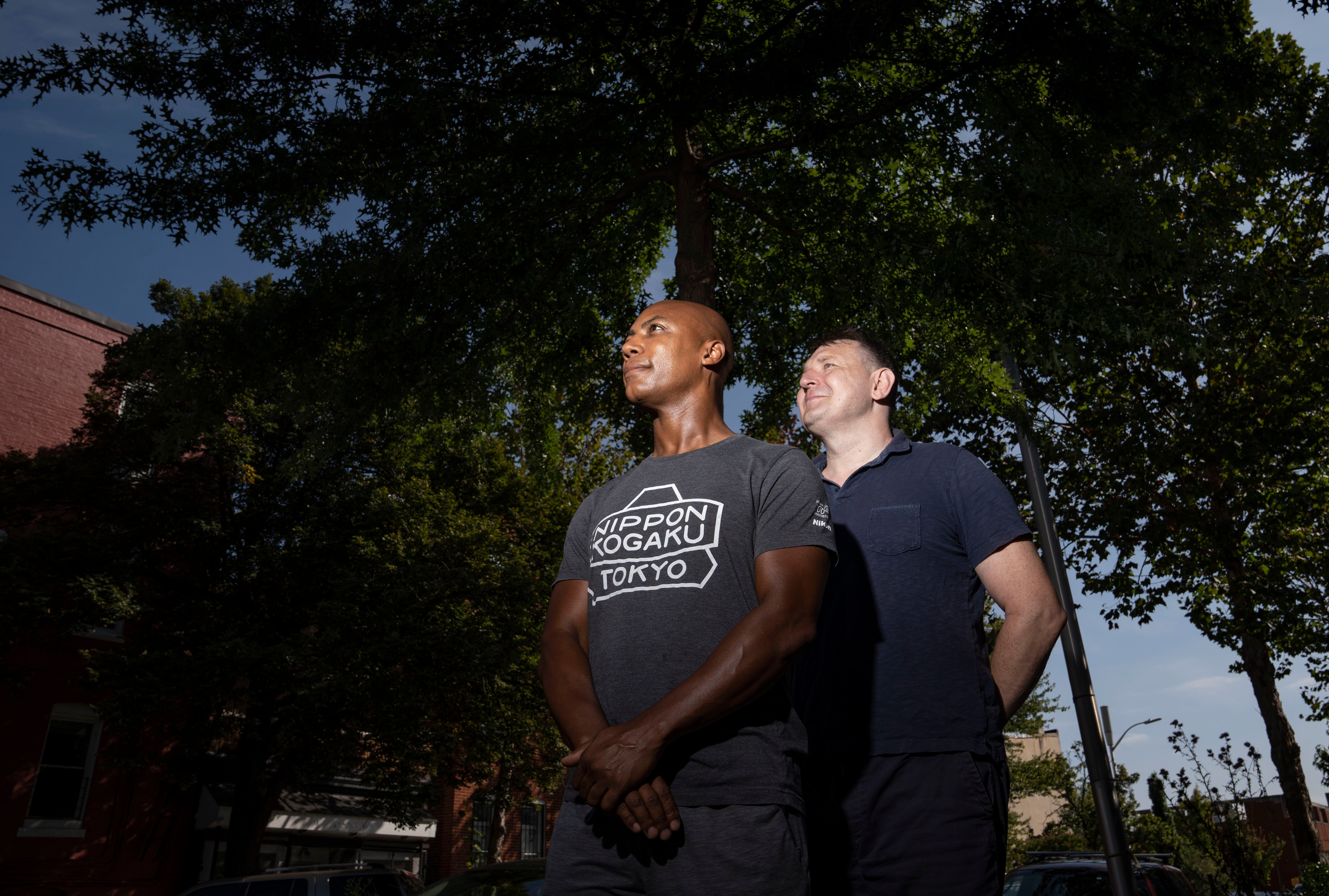 Kelly Cross and his husband Mateusz Rozanski pose for a portrait in their neighborhood, in Baltimore on Tuesday, Sept. 12, 2023.