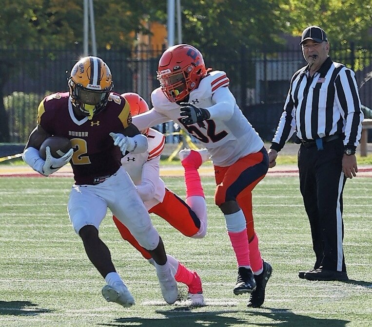Dunbar's Tristen Kenan (2) eludes Poly's Brayden Hurt during Friday's Baltimore City Division I football contest. Kenan rushed for 116 yards as the fifth-ranked Poets improved to 7-0 with a 24-6 victory over the previously undefeated and 12th-ranked Engineers at Sugar Cain Field in East Baltimore.