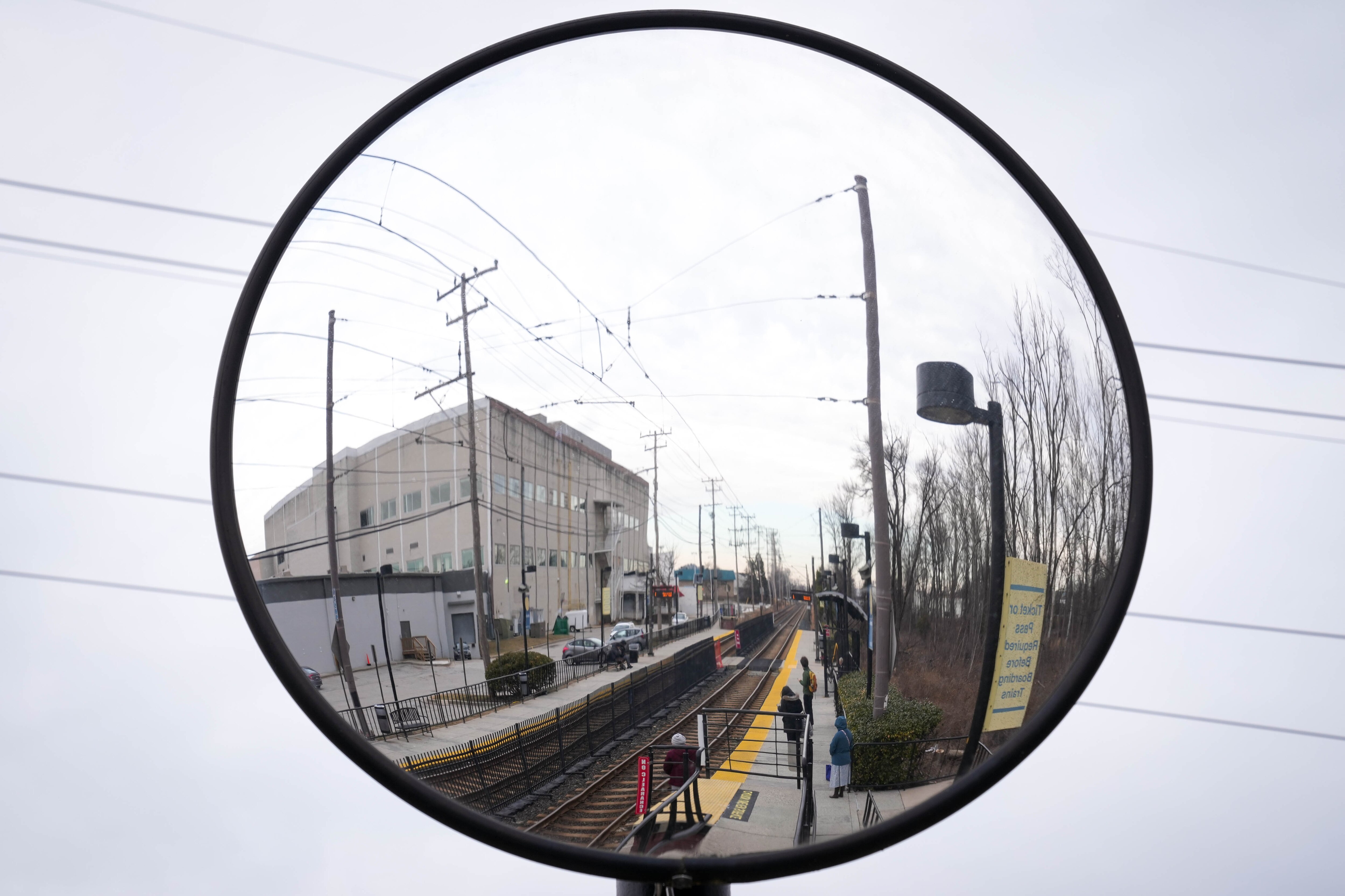 Passengers, reflected in a platform mirror, wait for their light rail to arrive at the Lutherville station in Lutherville, Md. on Monday, February 3, 2025.