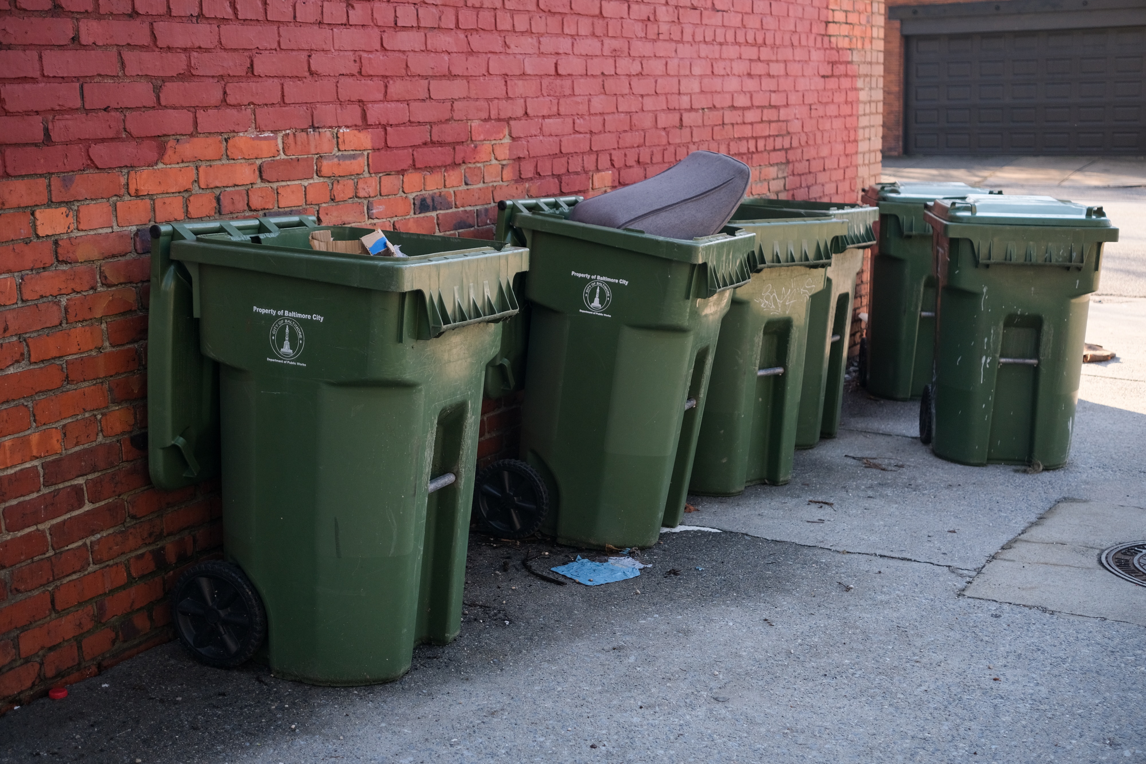 Garbage cans line an alley in Baltimore's Charles Village neighborhood.