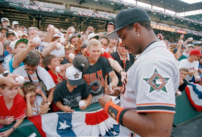 Fans standing several rows deep try for an autograph from san Francisco Giants outfielder Barry Bonds before the 1993 All-Star Game in Baltimore.