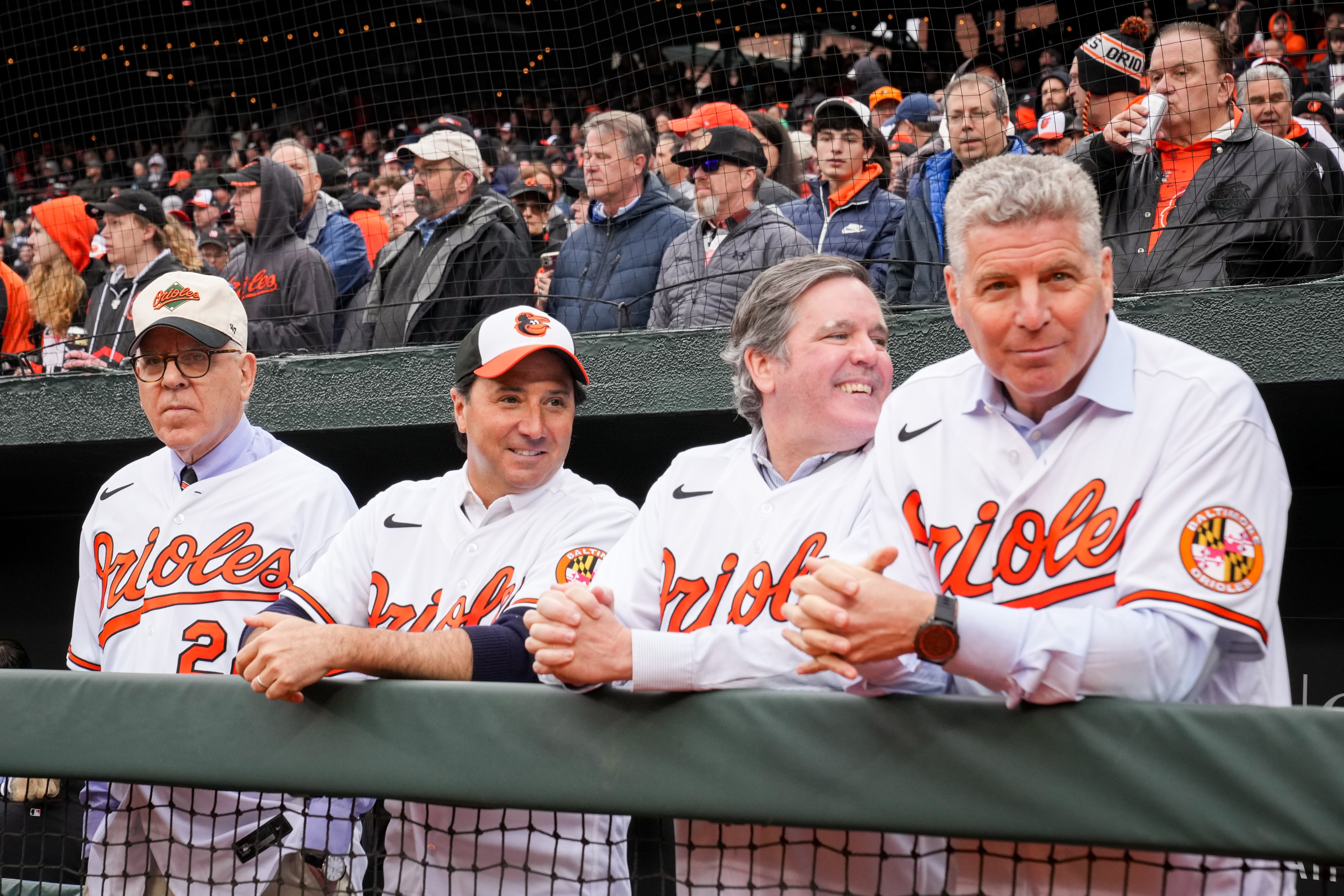 New Baltimore Orioles owner David Rubenstein, left, watches Opening Day festivities at Camden Yards from the dugout along with his co-owners, Michael Arougheti, Michael Smith and Mitchell Goldstein on Thursday, March 28, 2024. The Baltimore Orioles won their first game of the season, 11-3, against the Angels.