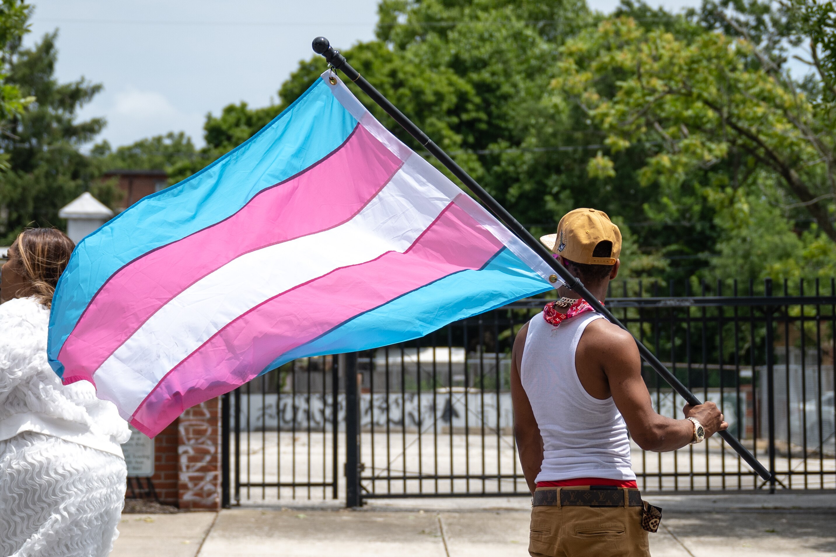 A participant in the Baltimore Trans Pride Grand March holds the Transgender Flag while marching in Baltimore, MD on 6/29/2024.