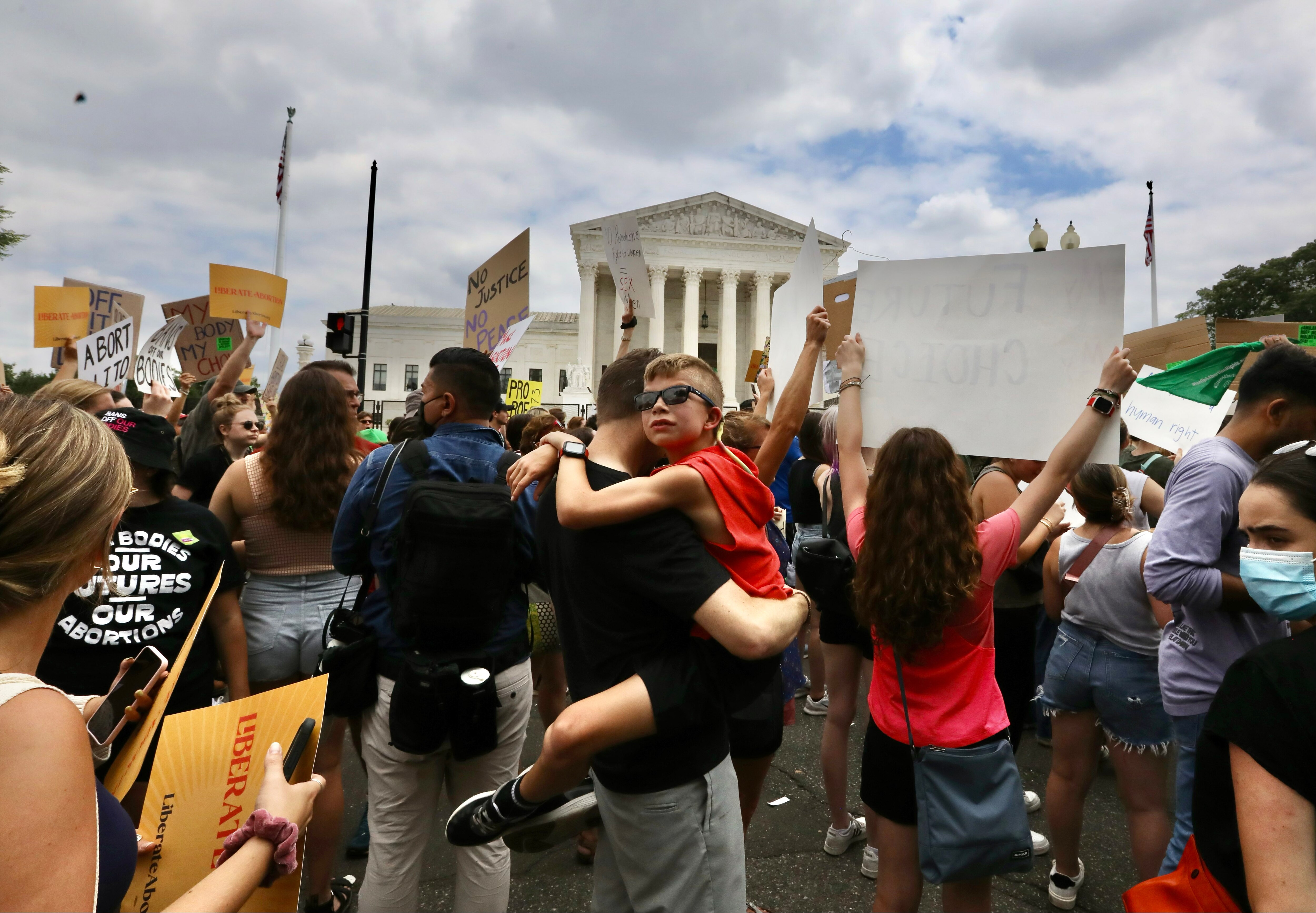Own Babiuch, 10, is held up by his father, Chris, during a protest after Roe v. Wade was overturned by the Supreme Court.