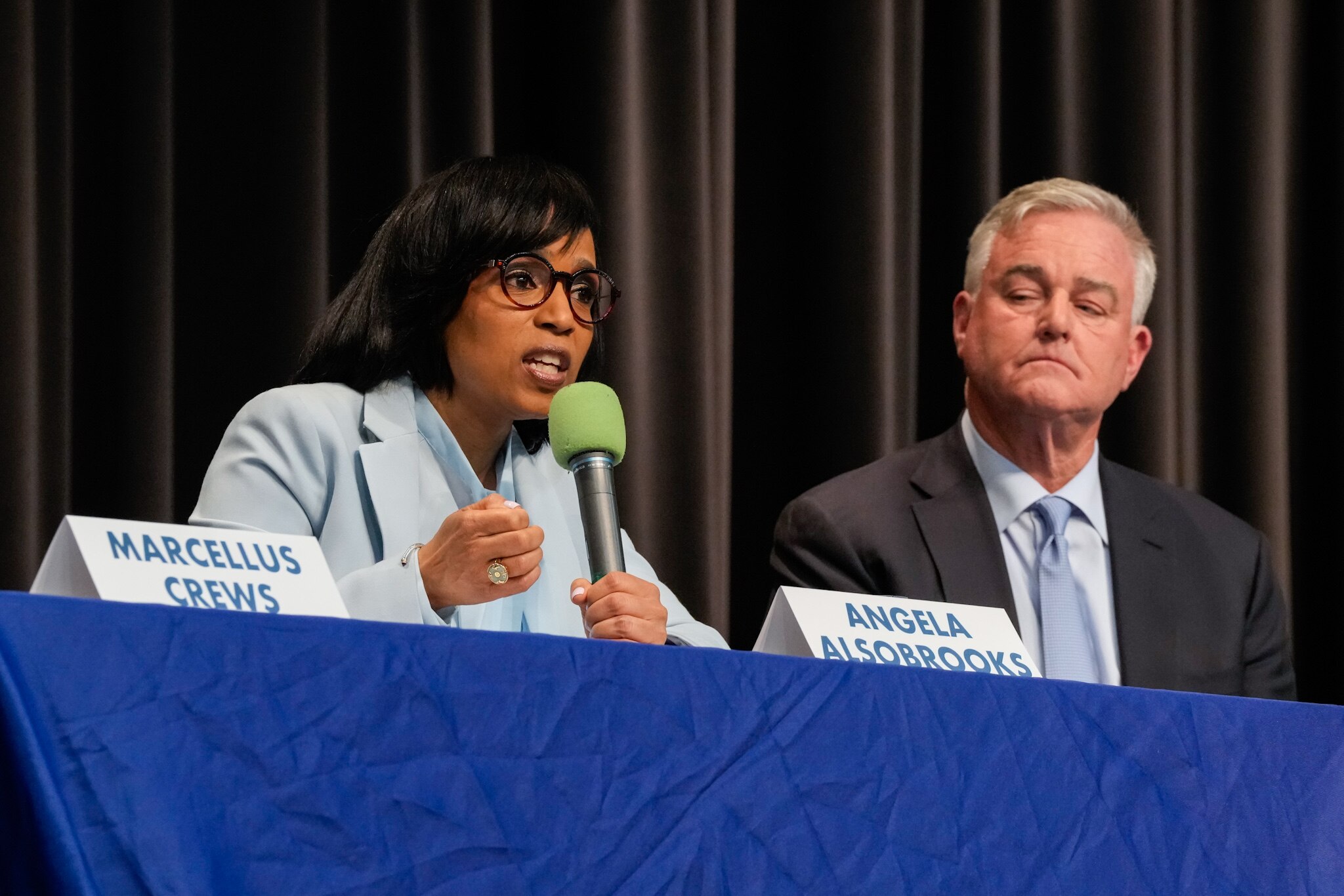 Prince George's County Executive Angela Alsobrooks speaks as U.S. Rep. David Trone listens during a forum with other U.S. Senate candidates at Montgomery Blair High School in Silver Spring, Maryland on Saturday, March 2, 2024.