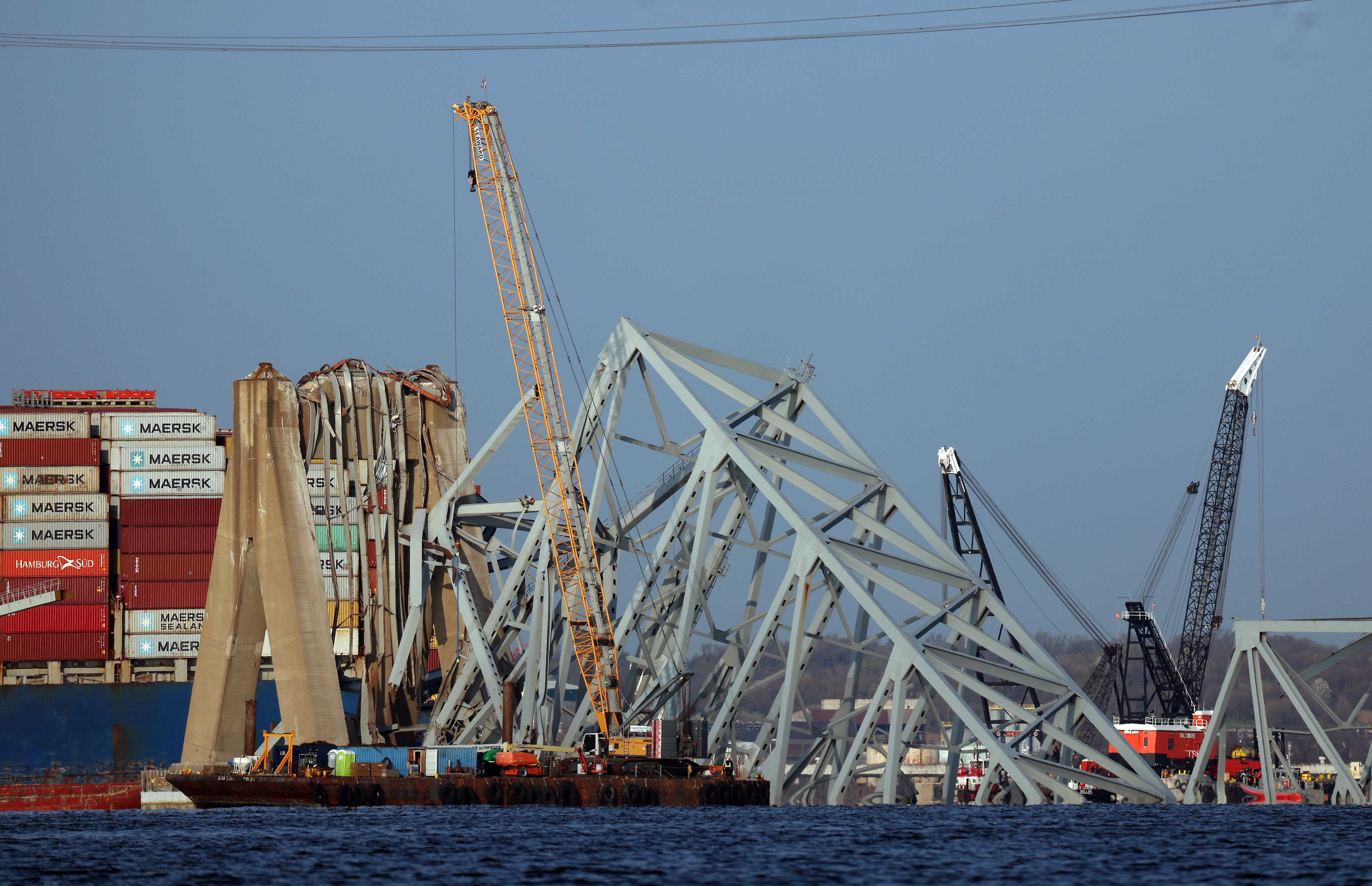 Cranes work on clearing debris from the Francis Scott Key Bridge on Friday.