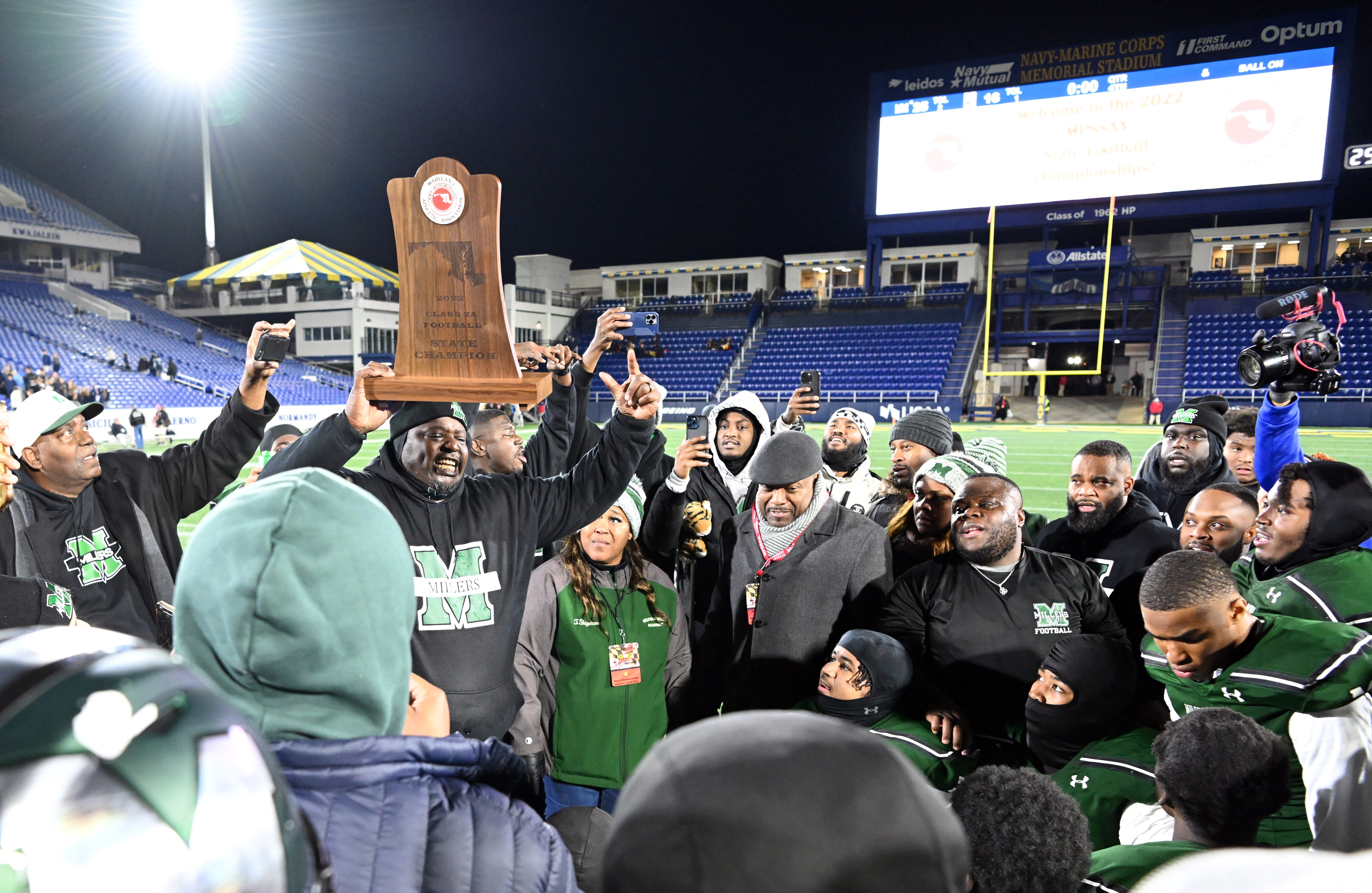 Milford Mill football coach Reggie White holds up the Class 2A state championship Friday evening. The No. 3 Millers won their first state championship since 1987 with a 25-16 victory over Kent Island at Navy-Marine Corps Memorial Stadium in Annapolis.