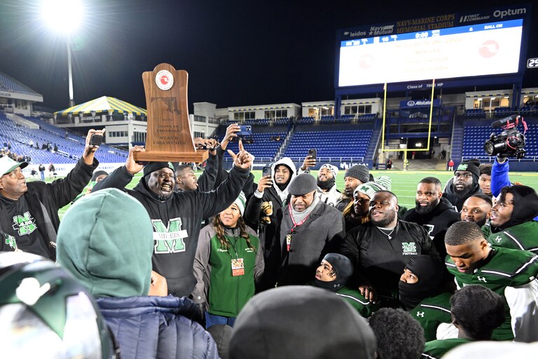 Milford Mill football coach Reggie White holds up the Class 2A state championship Friday evening. The No. 3 Millers won their first state championship since 1987 with a 25-16 victory over Kent Island at Navy-Marine Corps Memorial Stadium in Annapolis.