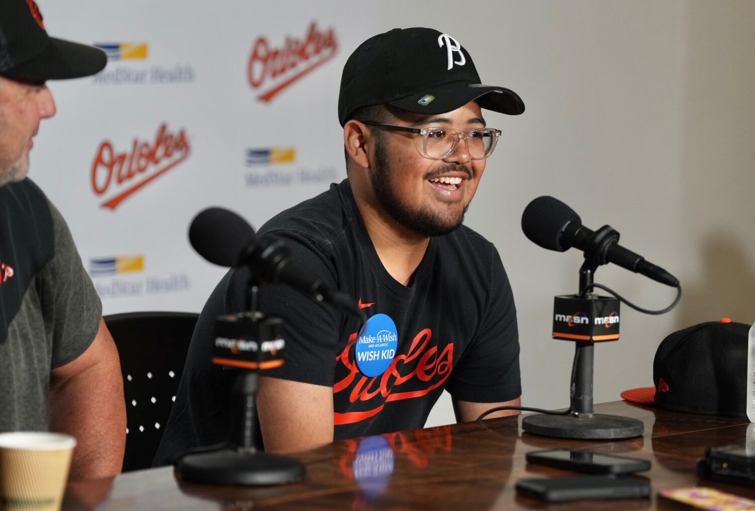 Luke Brockway, 17, from the Make-A-Wish Foundation, is manager for a day on July 18, 2023. He holds a press conference before the game with Orioles manager Brandon Hyde. (Kaitlin Newman/The Baltimore Banner)