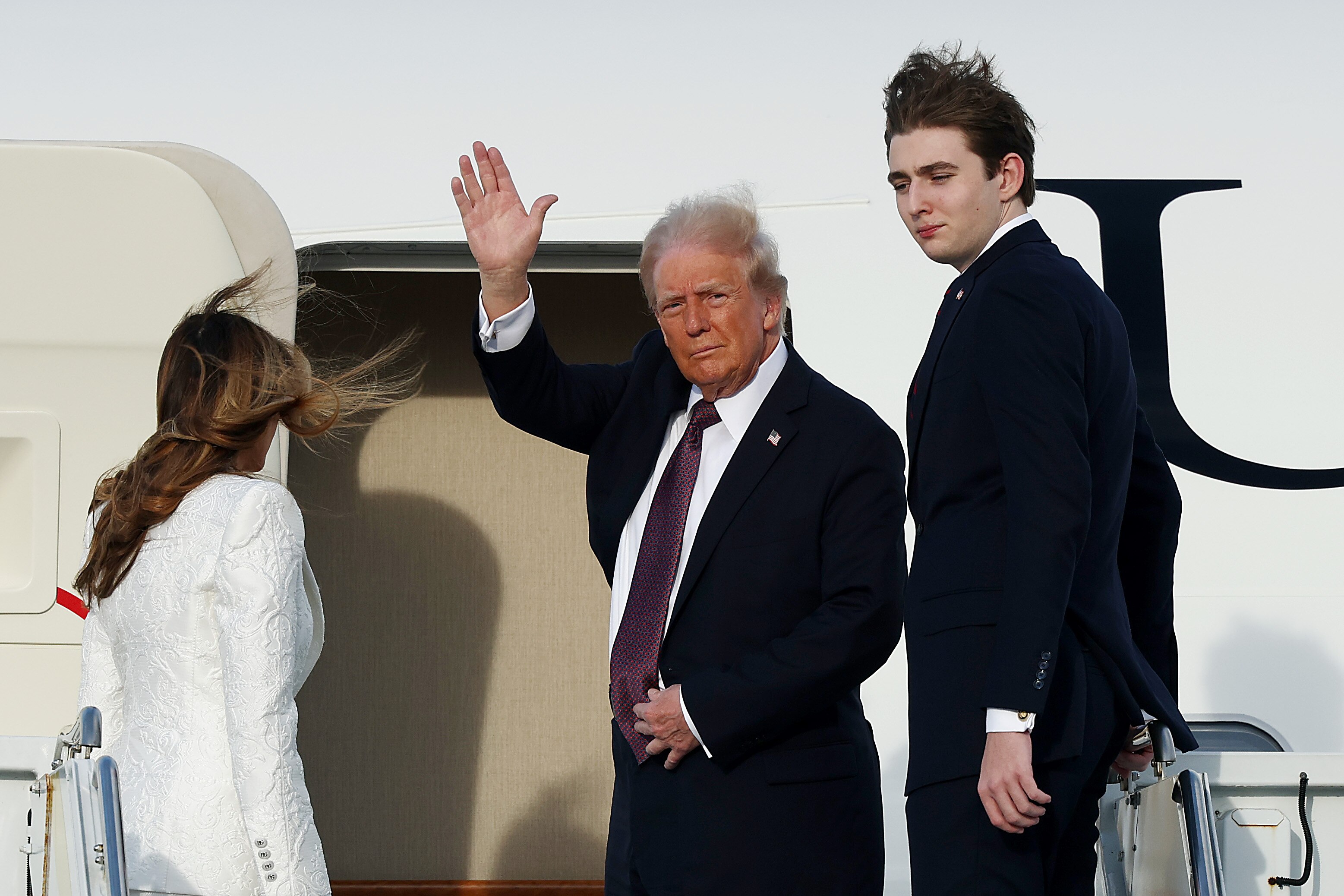 WEST PALM BEACH, FLORIDA - JANUARY 18: U.S. President-elect Donald Trump, Melania Trump and their son Barron board a U.S. Air Force aircraft en route to Dulles, Virginia on January 18, 2025 in West Palm Beach, Florida. Trump and Vice President-elect former Sen. JD Vance (R., Ohio) will be sworn in on January 20.