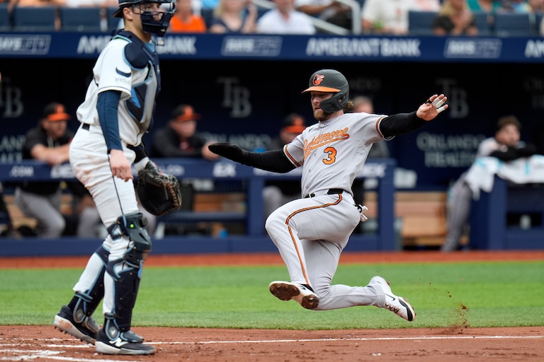 Baltimore Orioles' Taylor Ward (3) scores in front of Tampa Bay Rays catcher Hunter Feduccia on an RBI single by Pete Alonso during the third inning of a baseball game Wednesday, May 20, 2026, in St. Petersburg, Fla.