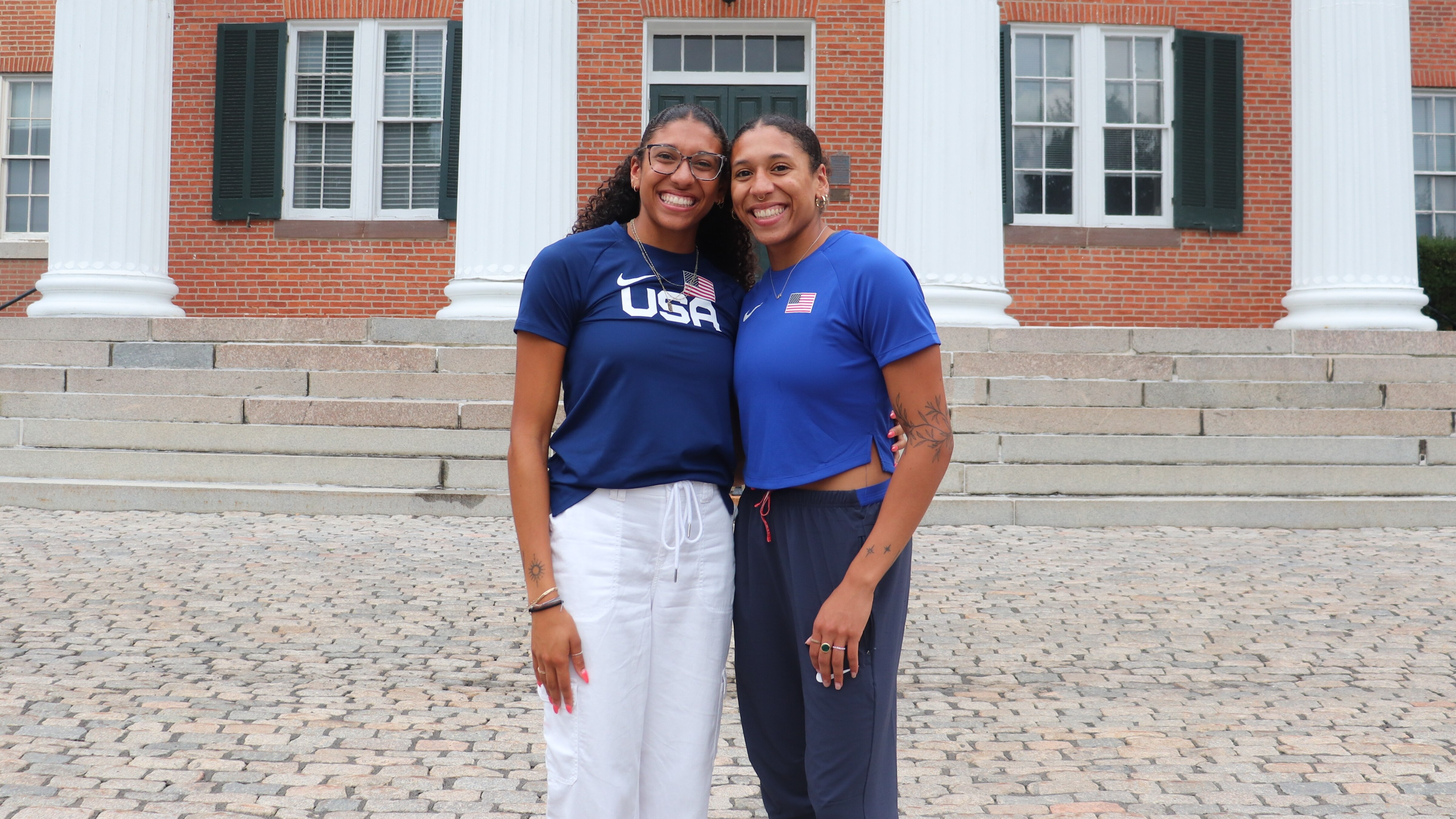 Juliette Whittaker, left, and Isabella Whittaker pose outside Mount de Sales Academy, where friends and supporters attended a send-off event before the sisters head to Paris to compete in the Olympics.