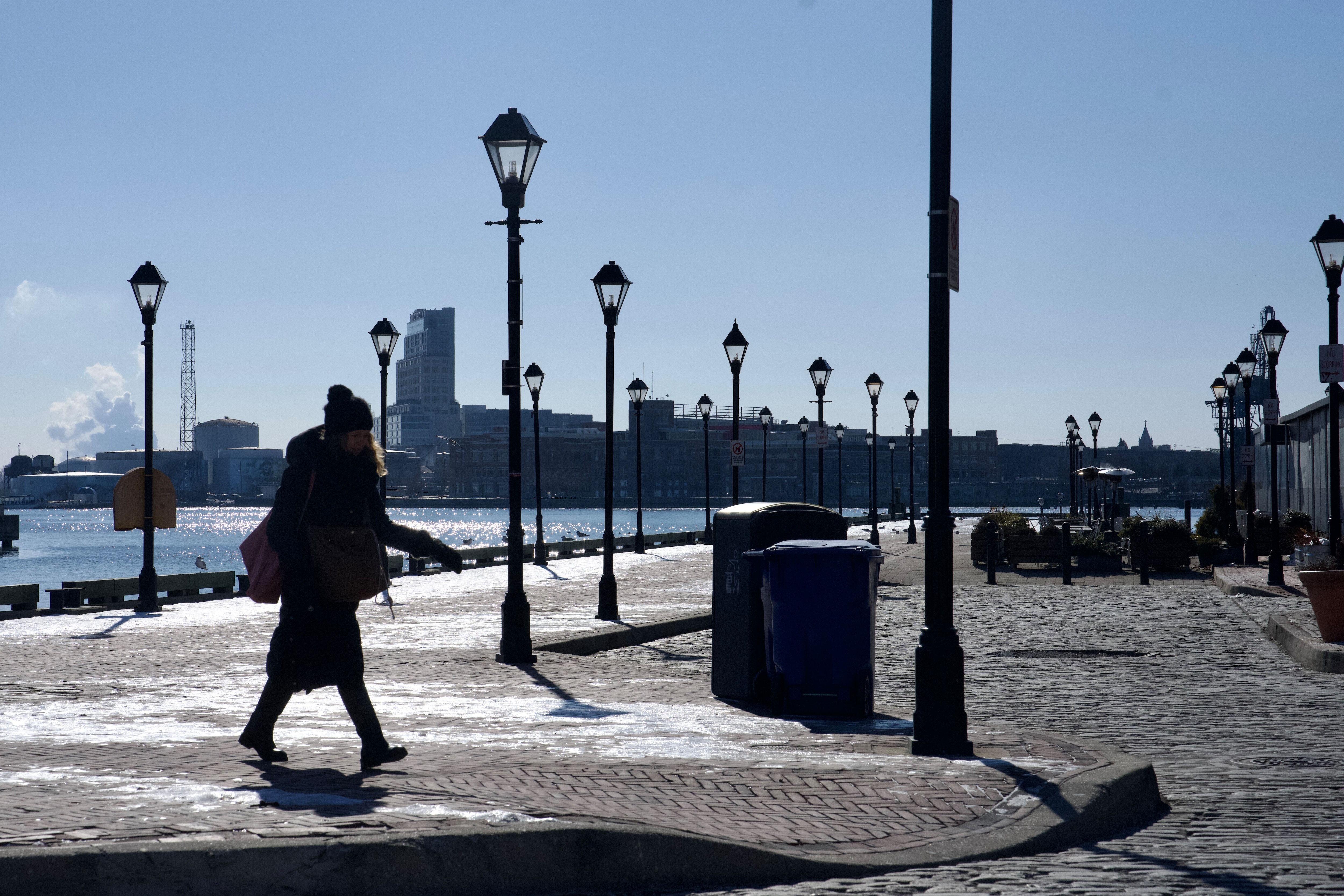 A person walks in Fells Point, Baltimore, on Wednesday, January 22, 2025. Below freezing conditions persisted in Maryland Wednesday morning, accompanied by wind gusts making it feel close to zero degrees in parts of the state. The extreme cold warning for western Maryland and the cold weather advisory for the rest of the state — including Baltimore City and Baltimore, Howard, Anne Arundel, Harford and Carroll counties — remain in effect until Thursday morning at 10 a.m.