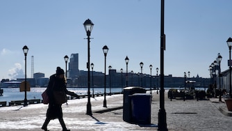 A person walks in Fells Point, Baltimore, on Wednesday, January 22, 2025. Below freezing conditions persisted in Maryland Wednesday morning, accompanied by wind gusts making it feel close to zero degrees in parts of the state. The extreme cold warning for western Maryland and the cold weather advisory for the rest of the state — including Baltimore City and Baltimore, Howard, Anne Arundel, Harford and Carroll counties — remain in effect until Thursday morning at 10 a.m.