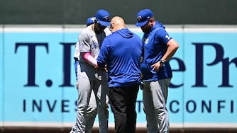 BALTIMORE, MD - MAY 31: Jesús Sánchez #12 of the Toronto Blue Jays is checked by a trainer after a ball thrown from the outfield stands struck him in the sixth inning against the Baltimore Orioles at Oriole Park at Camden Yards on May 31, 2026 in Baltimore, Maryland. Sánchez would leave the game after the incident.