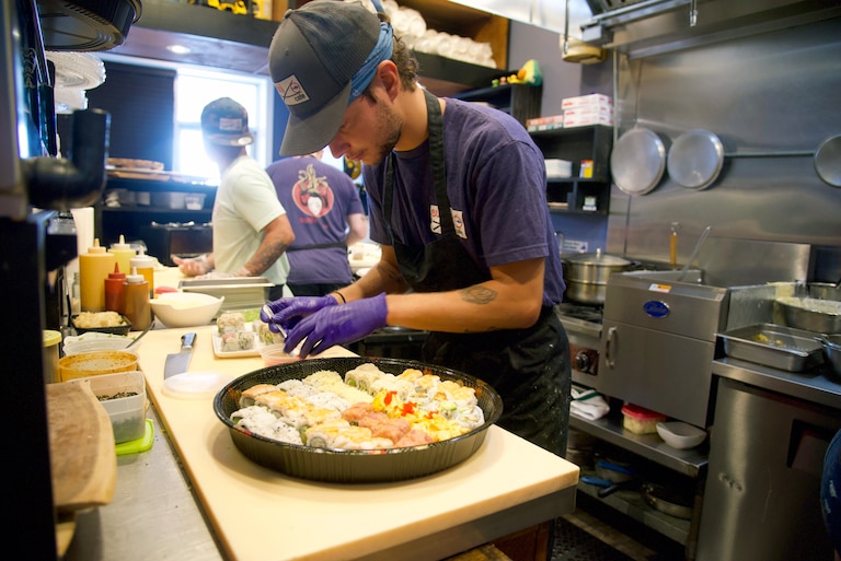 Tony Romero prepares a fresh sushi platter during a dinner shift at Sushi Cafe, located in a 139th Street shopping center in Ocean City.