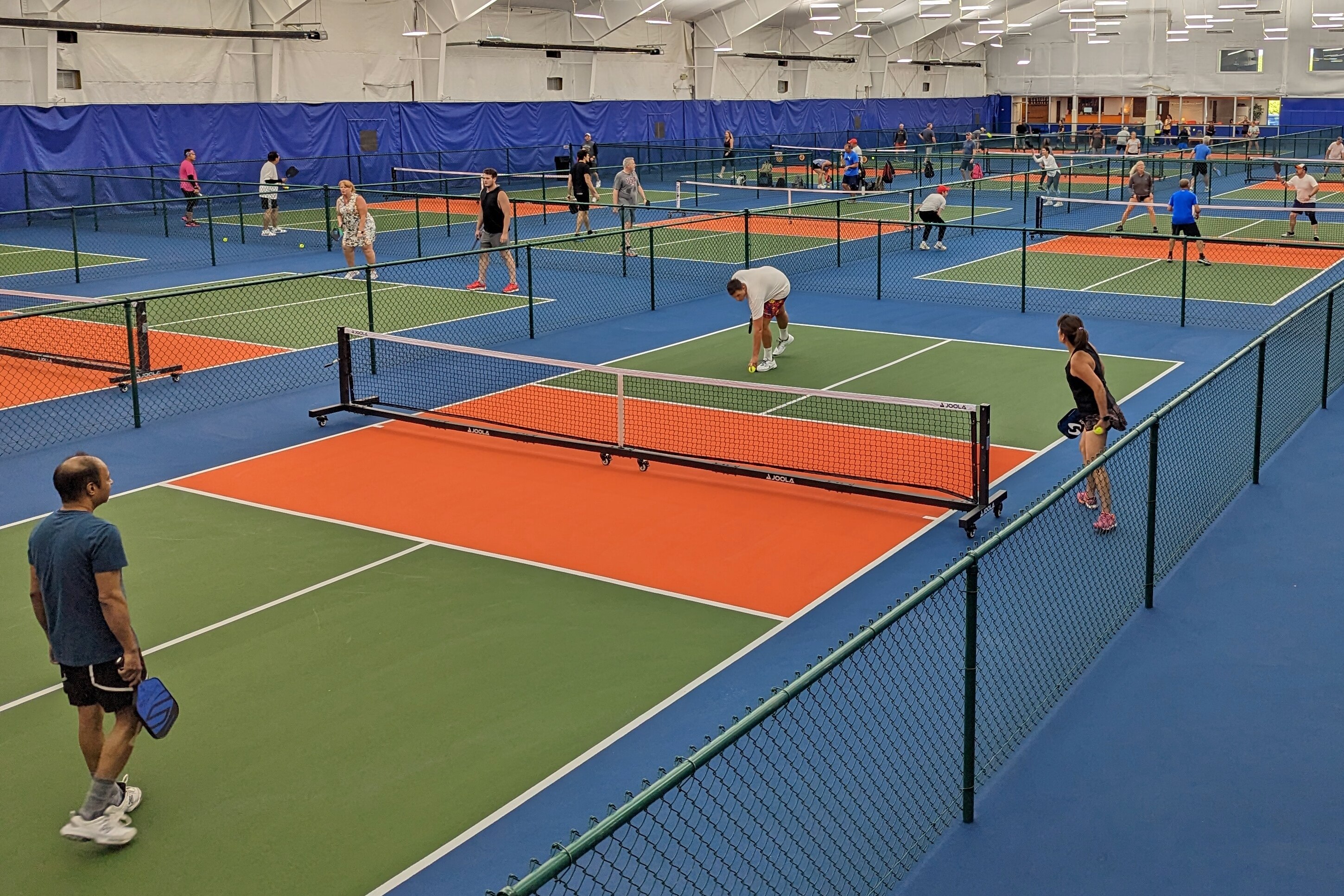 People play pickleball on opening day at the Dill Dinkers' Finksburg location of their indoor pickleball court franchise.