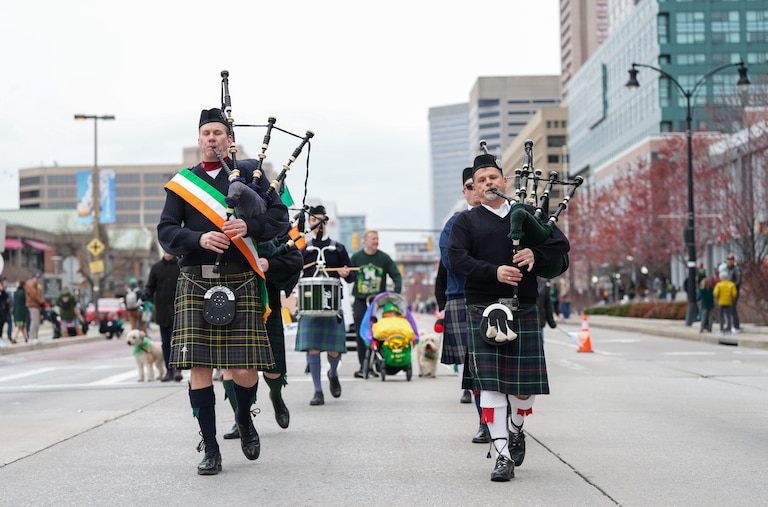 Bag pipe players play traditional Irish music while they march down Pratt St. in the annual St. Patricks Day Parade in Baltimore City, MD., on March 12, 2023.