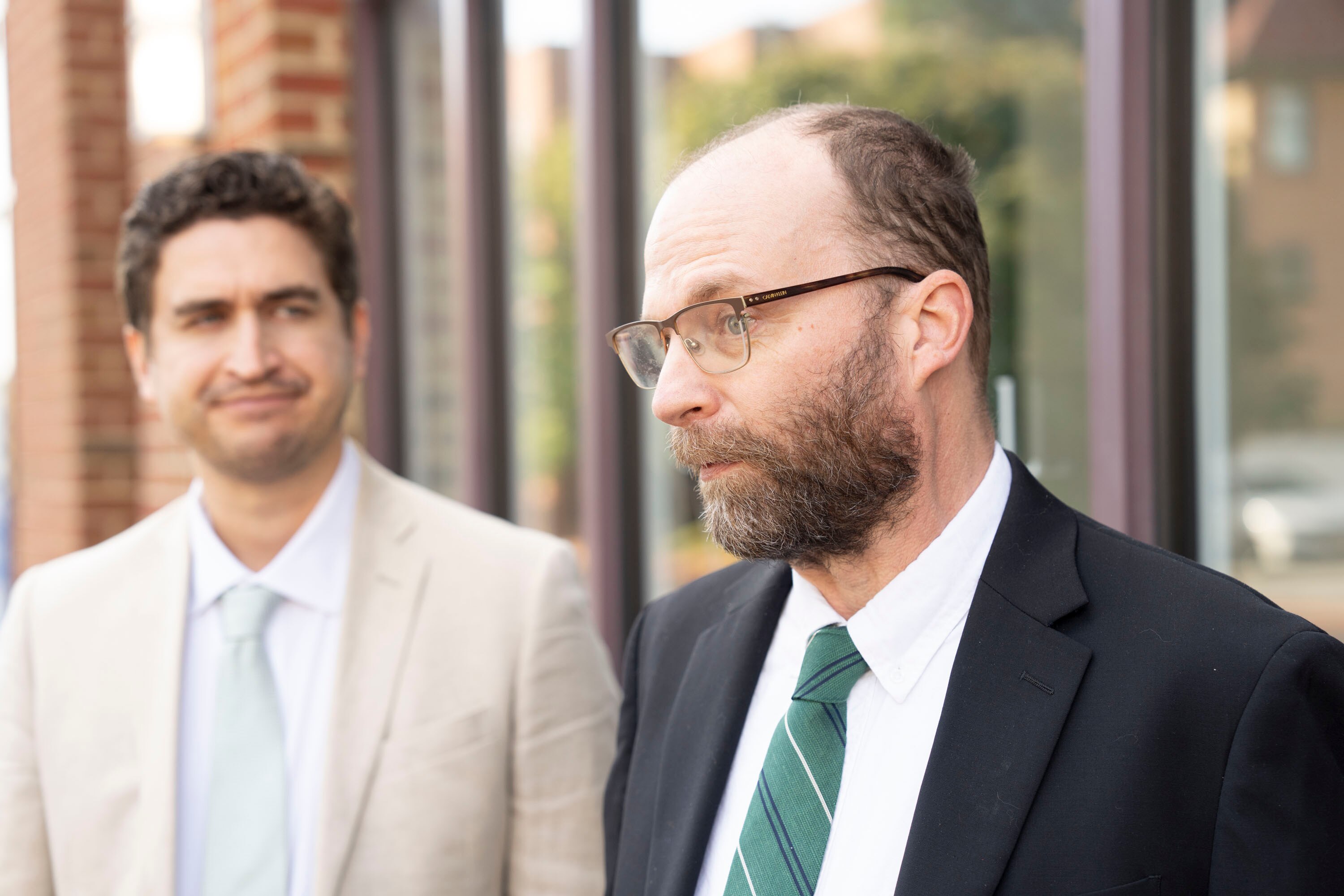 Green Party gubernatorial candidate Andy Ellis, right, and his running mate, Owen Silverman Andrews, file for office in September 2025.