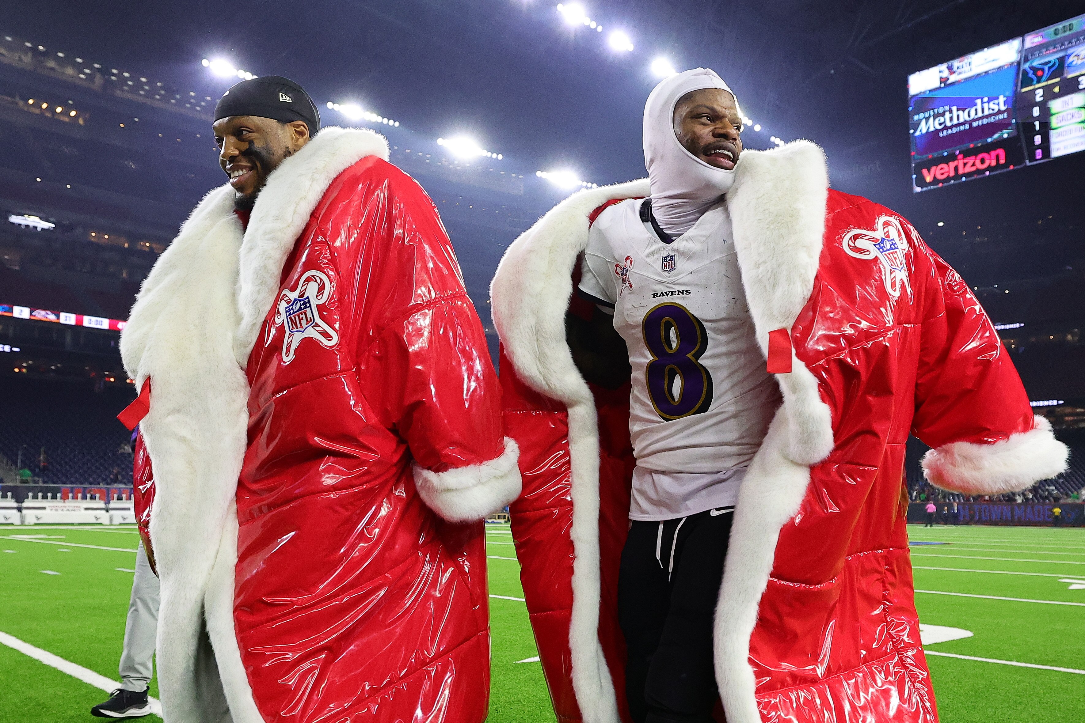 HOUSTON, TEXAS - DECEMBER 25: Derrick Henry #22 and Lamar Jackson #8 of the Baltimore Ravens walk off the field after a game at NRG Stadium on December 25, 2024 in Houston, Texas.