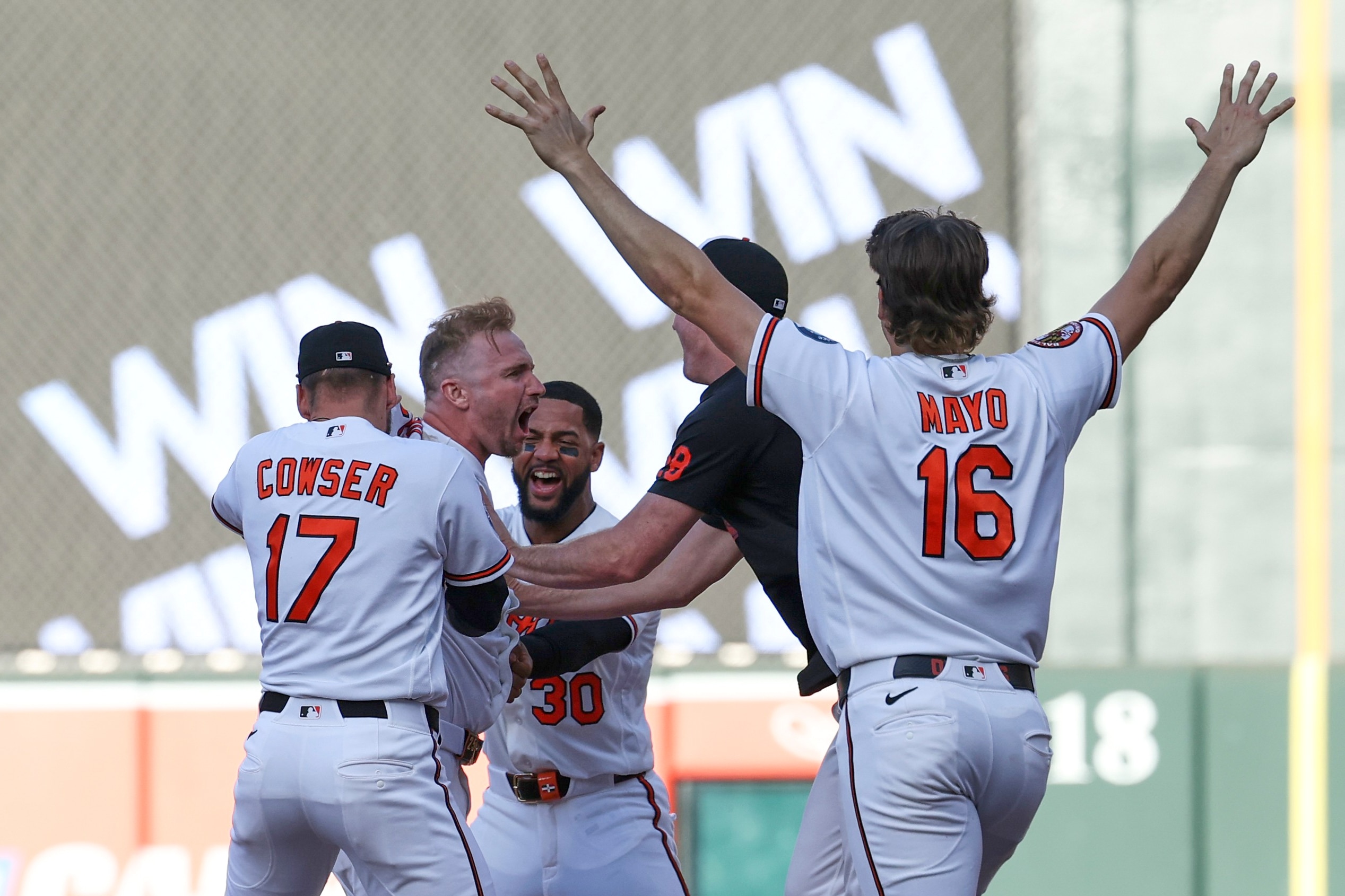 Teammates surround Pete Alonso after he drove in the winning run in the bottom of the ninth Saturday as the Orioles beat the Blue Jays 6-5.