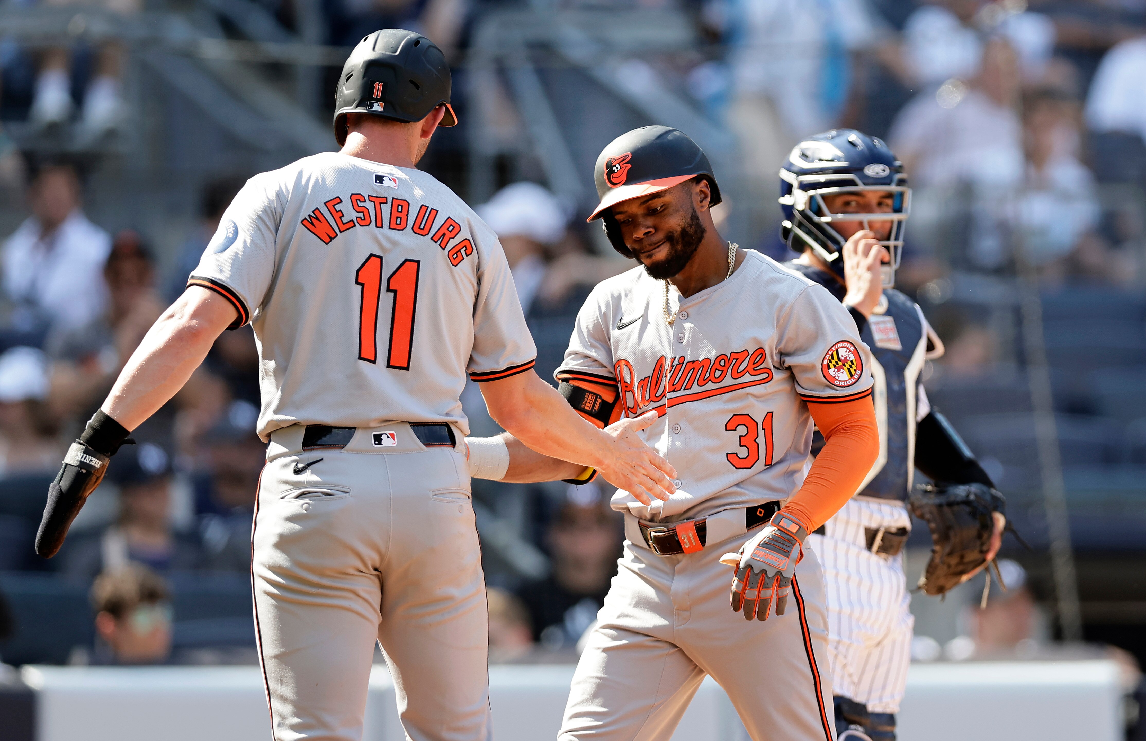 Orioles outfielder Cedric Mullins slaps hands with Jordan Westburg after a home run by Mullins in the second inning Thursday.