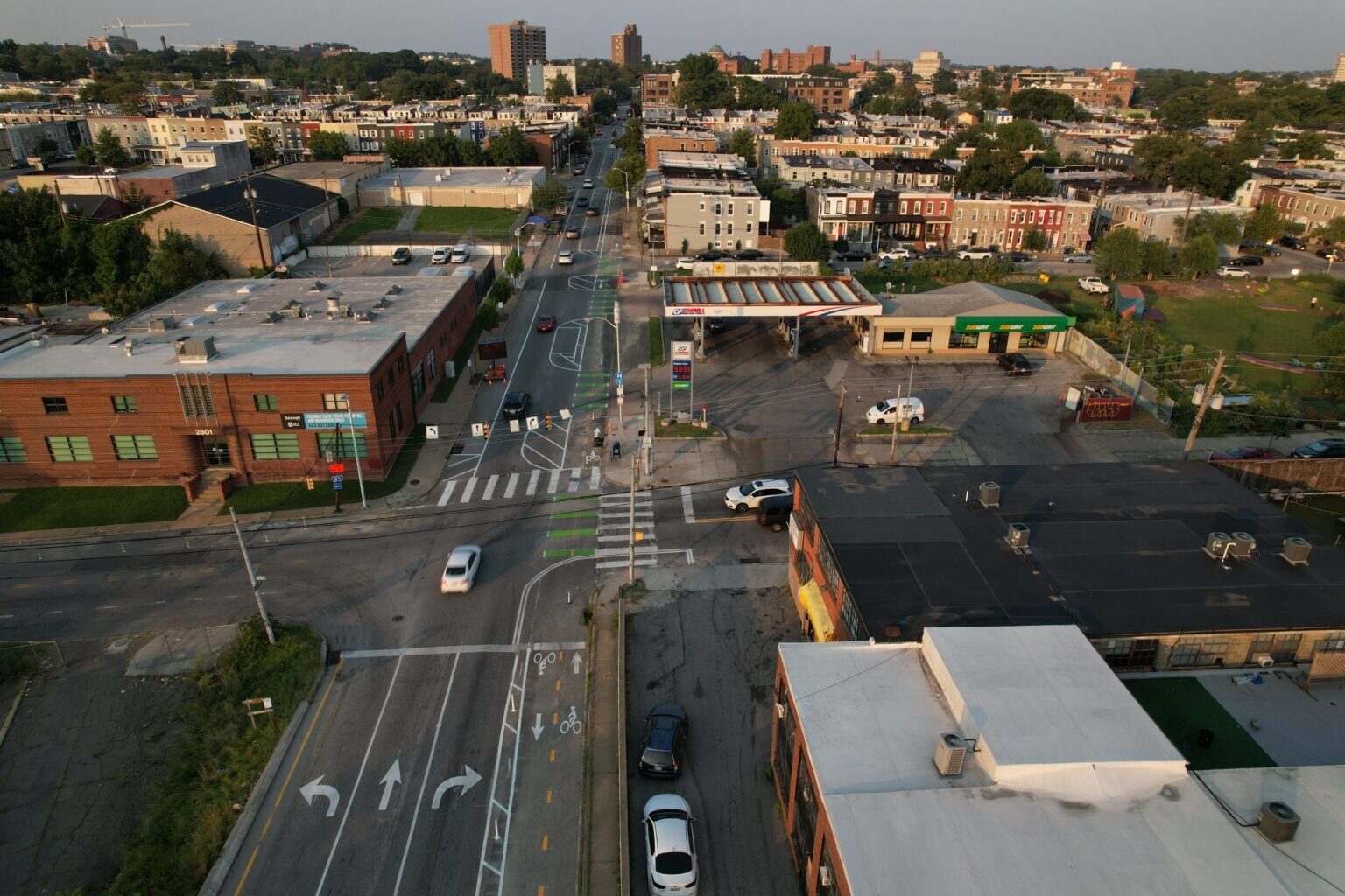 A drone view of a city intersection and surrounding buildings.