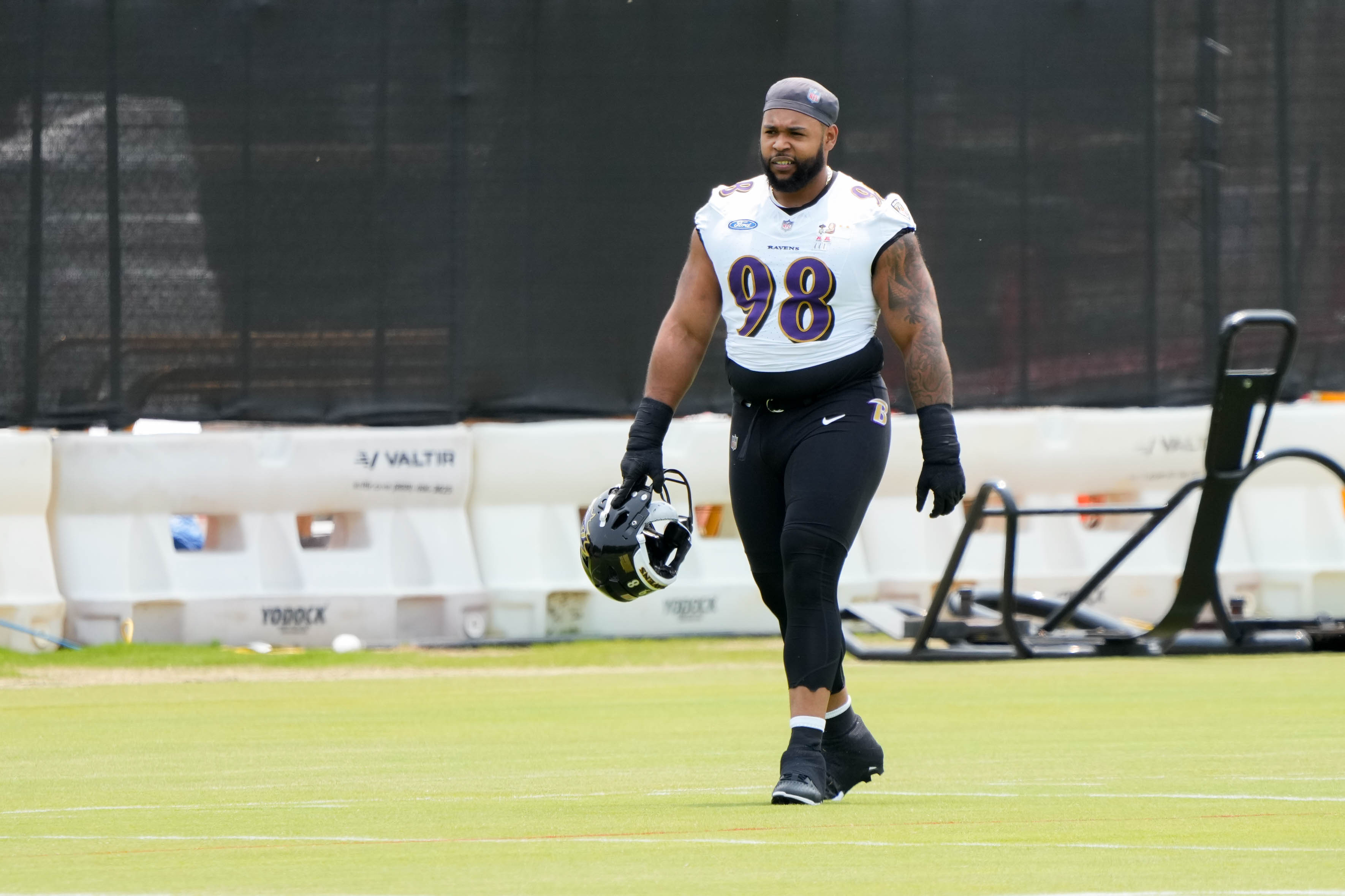 Defensive lineman Travis Jones walks onto the practice field during the team’s organized team activities on June 3.