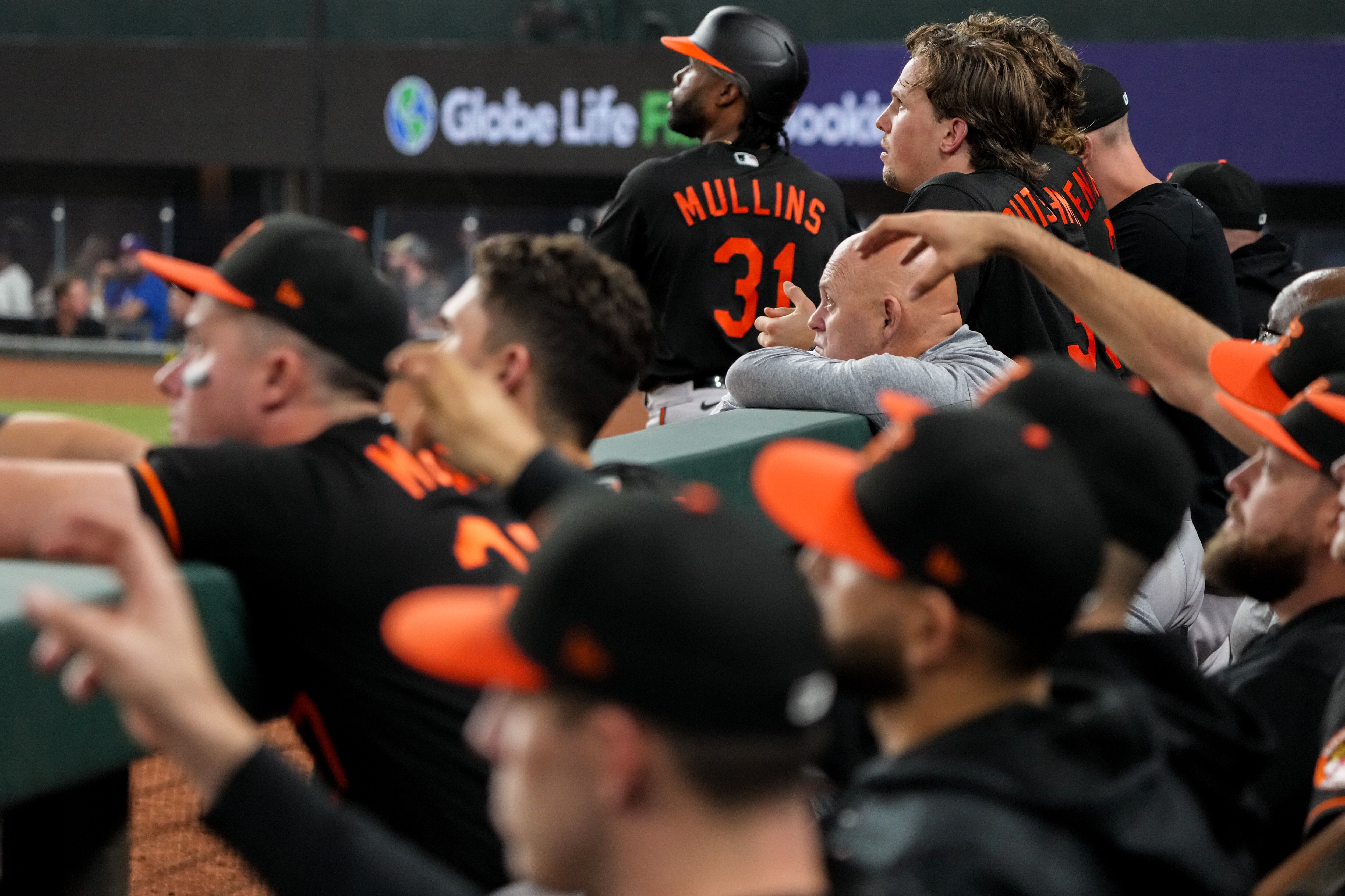 Baltimore Orioles center fielder Cedric Mullins and catcher Adley Rutschman watch the game from the dugout during Game 3 of the American League Division Series against the Texas Rangers at Globe Life Field in Arlington, Texas, on Tuesday, Oct. 10, 2023.