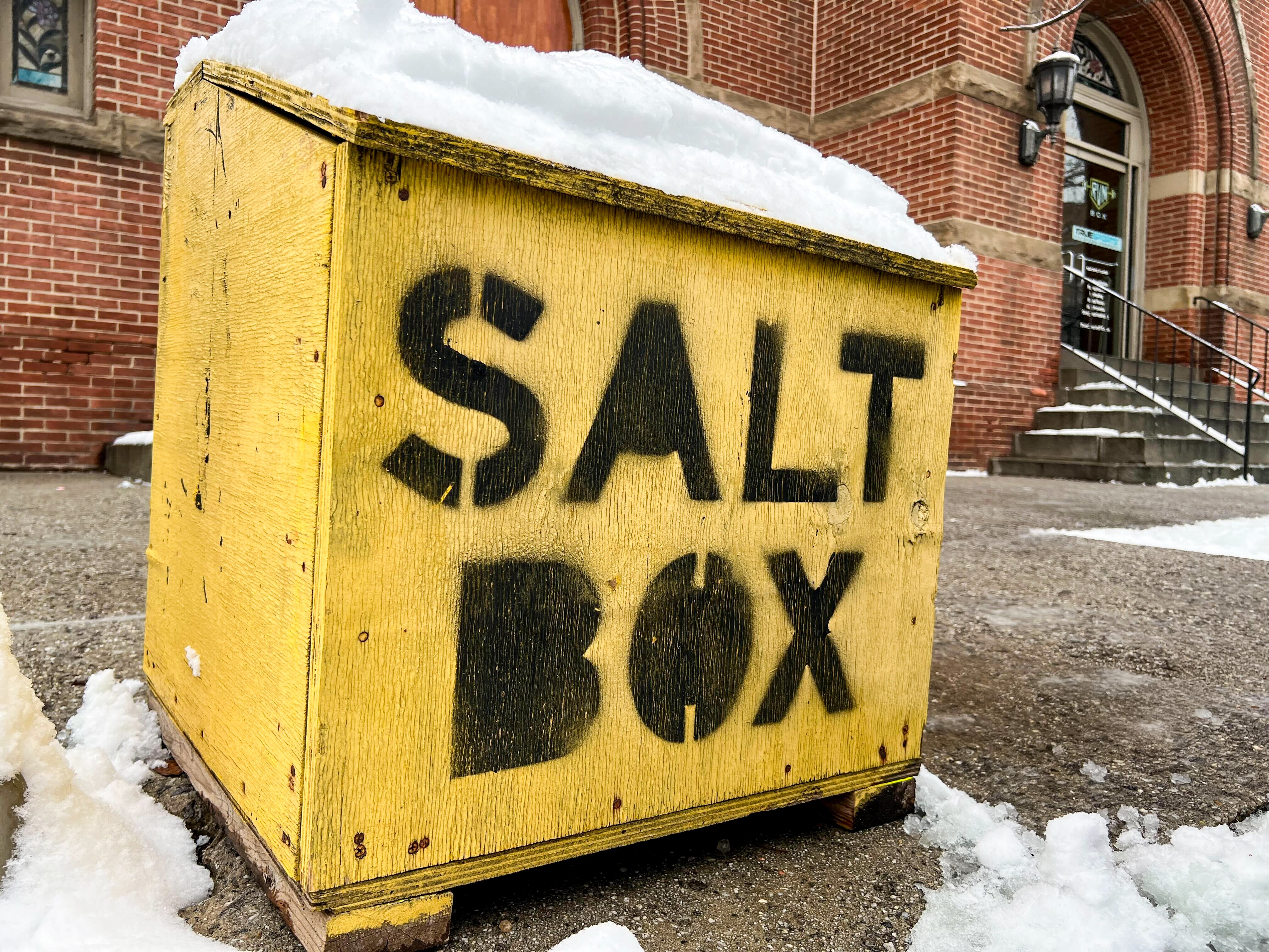 A salt box with snow on top is seen on South Ann Street before Lancaster Street in Fells Point on Wednesday, Feb. 12, 2025.