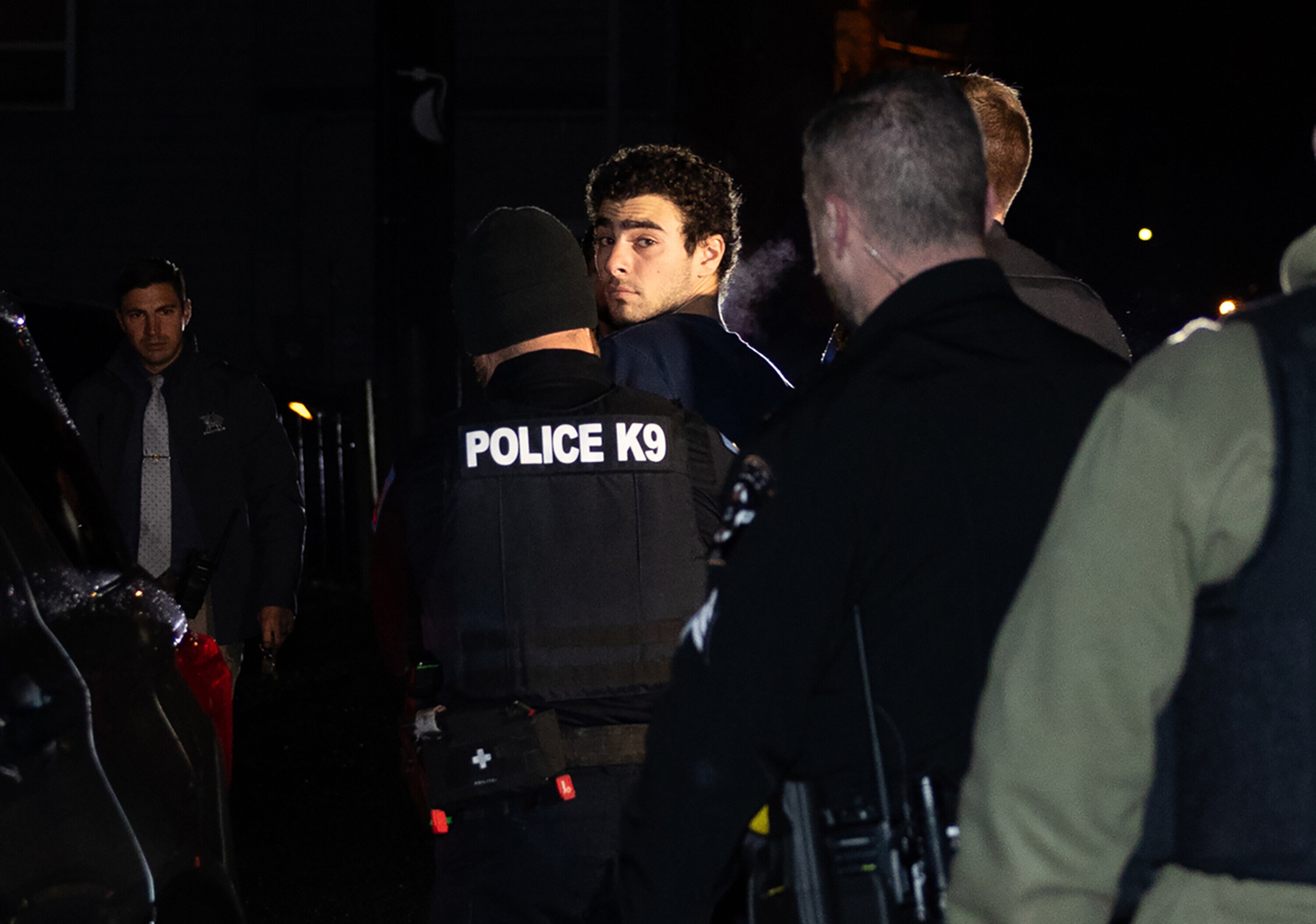 Luigi Mangione is escorted by police to his arraignment at the Blair County Courthouse in Hollidaysburg, Pa., Monday, Dec. 9, 2024. The 26-year-old Maryland native was  arrested in Altoona, Pa., on gun charges and for questioning in connection with last week's killing of a health insurance executive in Midtown Manhattan that prompted a manhunt up and down the East Coast, the New York Police Department said.
