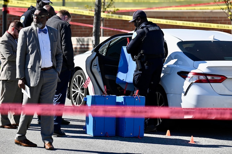 Baltimore Police remove what appears to be ballot boxes from a Toyota Camry from the scene of a police-involved shooting in the Belair-Edison neighborhood in East Baltimore on Thursday in Baltimore, Md. Thursday, October 22, 2026.