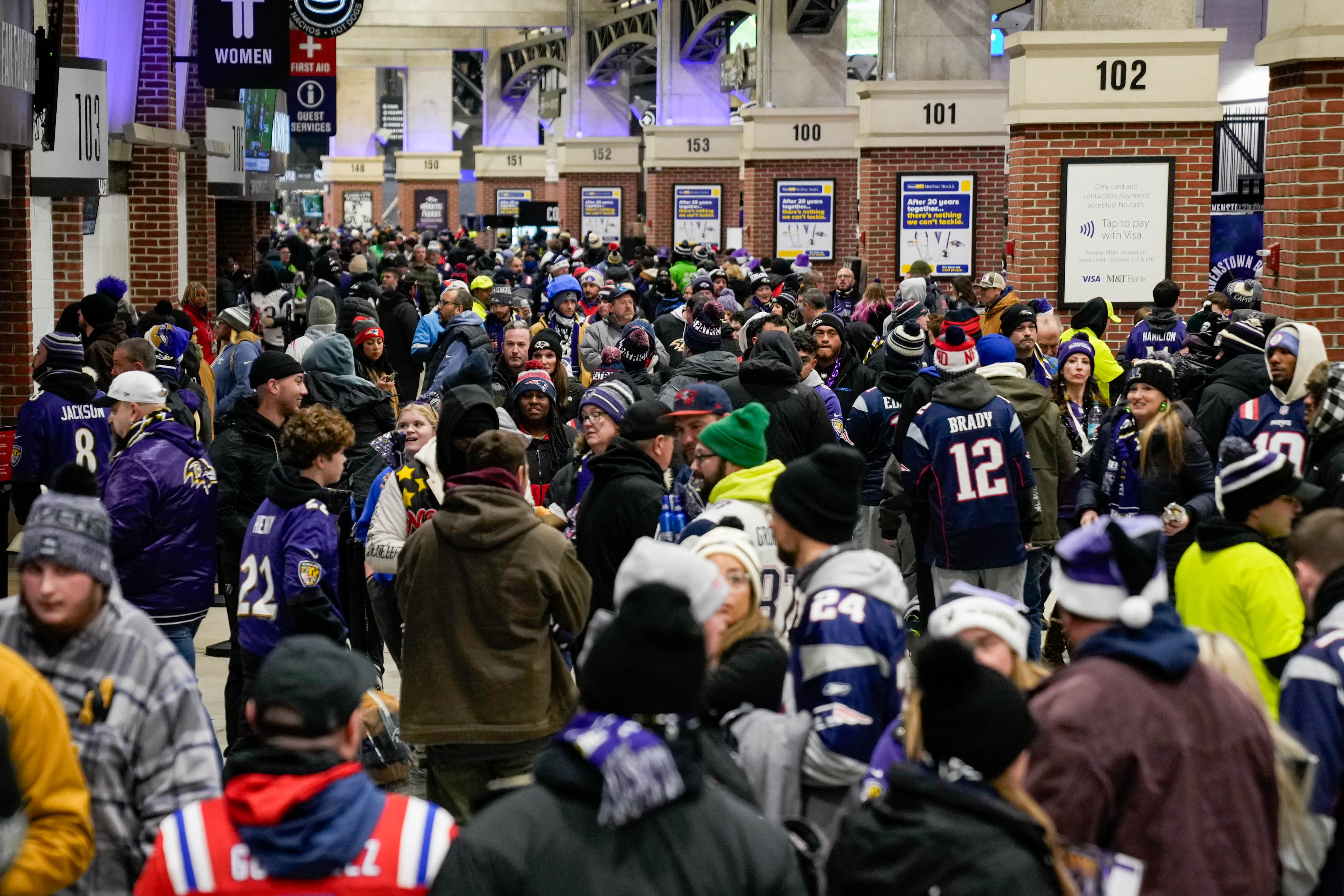 A large crowd of fans moves through the concourse to find their seats ahead of the Week 16 game between the Baltimore Ravens and the New England Patriots on Dec. 21, 2025.