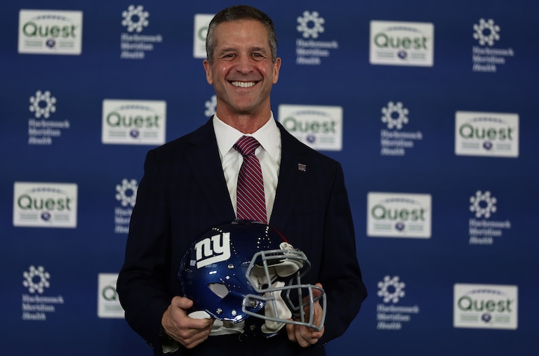 New York Giants head coach John Harbaugh poses for a photo after being introduced during a news conference Tuesday.