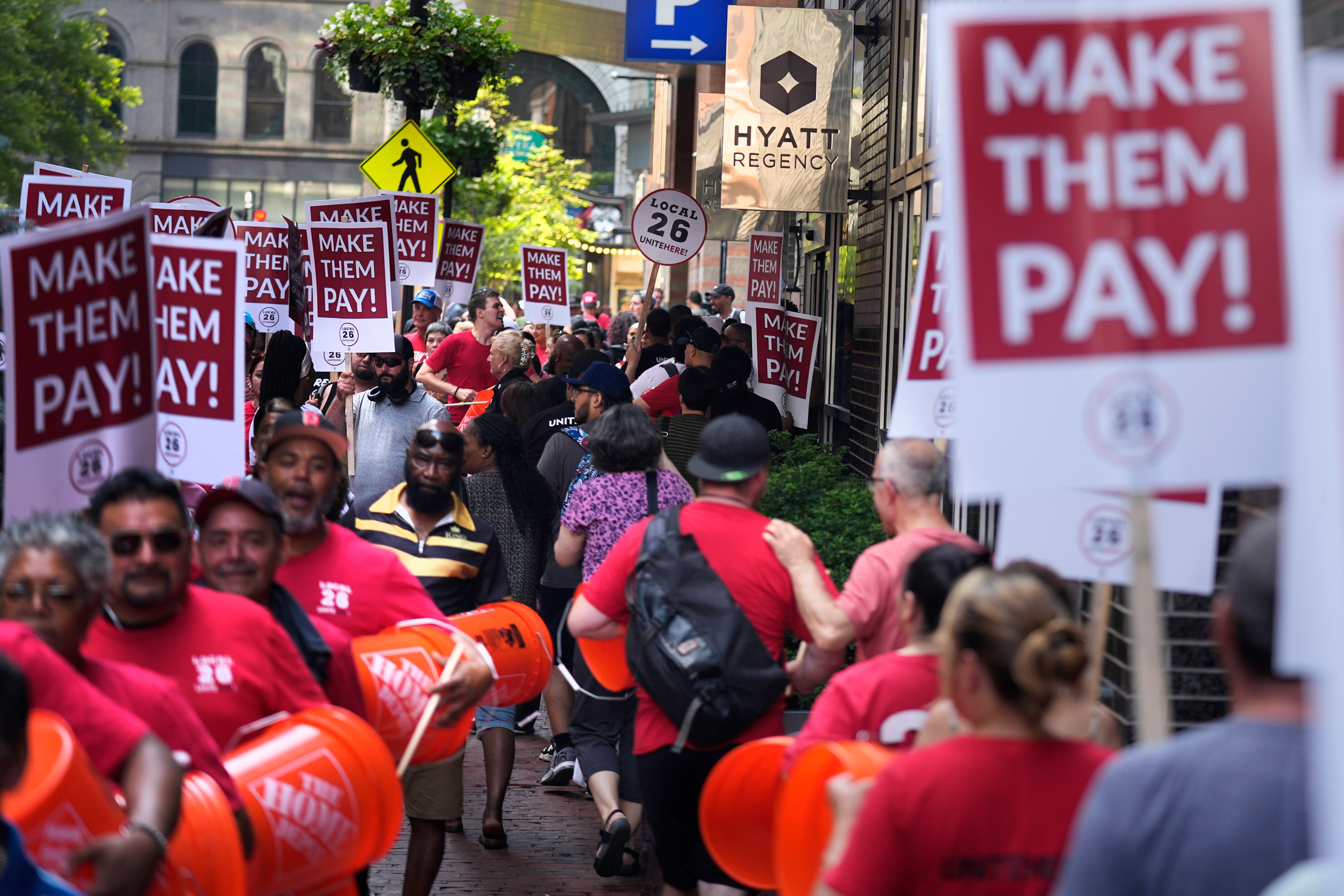 Hotel workers in eight cities walked off the job on Sunday to demand better wages and working conditions. (AP Photo/Charles Krupa)
