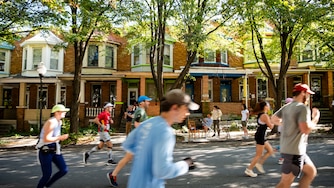 Runners pass through the Charles Village neighborhood during the 2024 Baltimore Running Festival on Saturday, October 19, 2024.