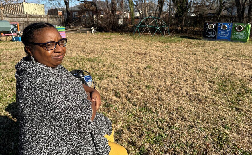 Tiffany Thompson sits on a bench amongst the remnants of a community lot where neighbors encouraged each other to reduce, reuse and recycle in Curtis Bay.