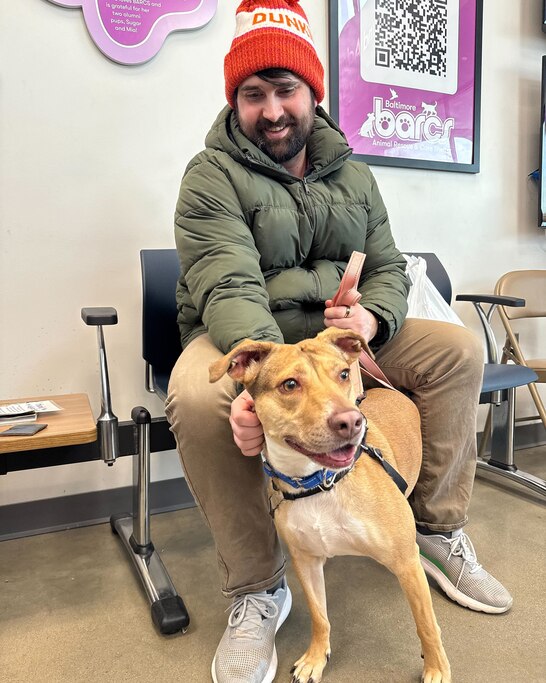 Jonathan Snack petting his short term foster dog, Jetsen, at Baltimore Animal Rescue and Care Shelter (BARCS). Snack said Jetsen might stay longer term with his family after the weekend.