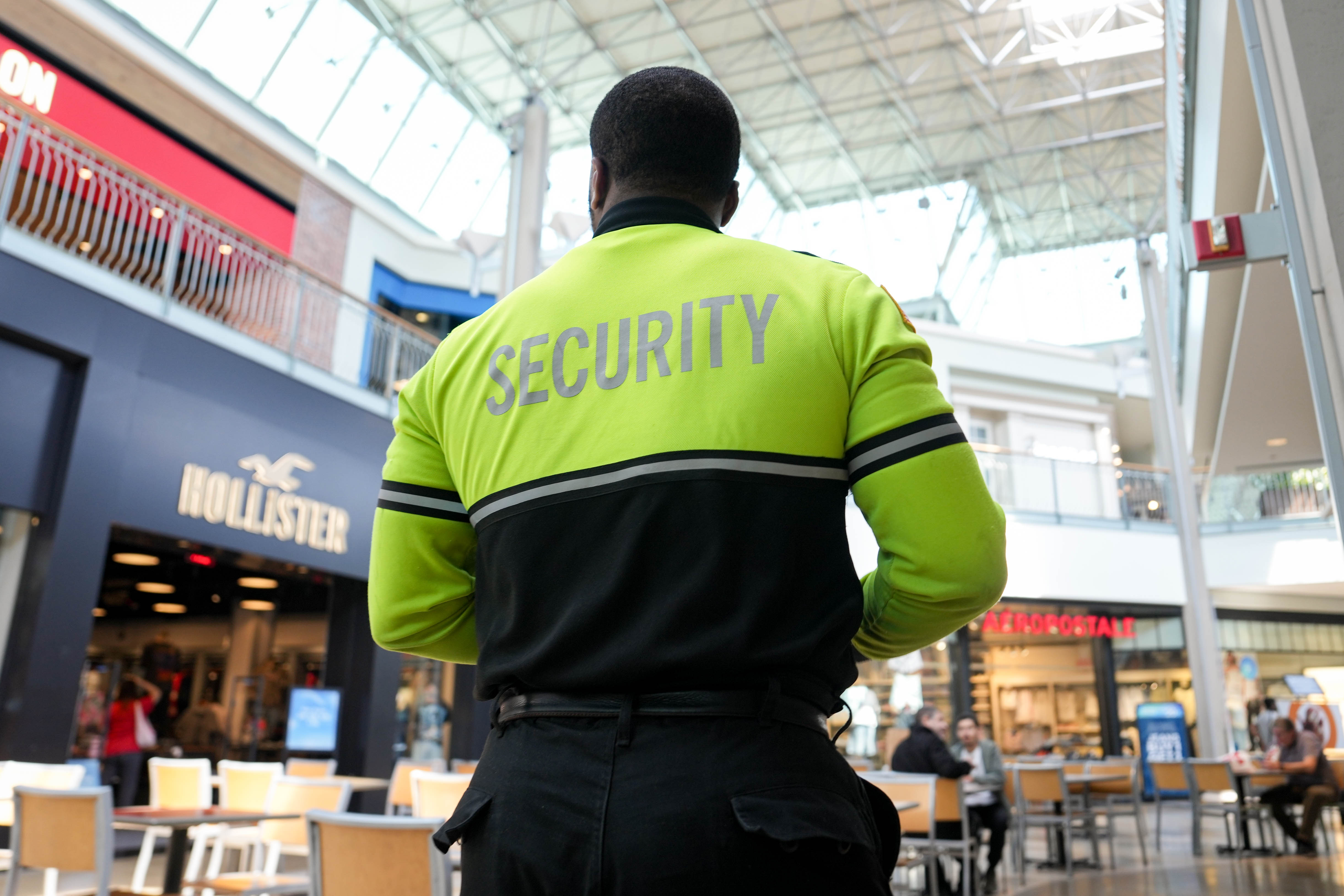 Ofc. Brian Onwezi walks through the Mall in Columbia in Columbia, Md. on Monday, May 19, 2025.