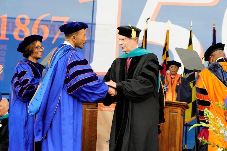 Sheldon Goldseker shakes hands with Congressman Kweisi Mfume at Morgan State University's commencement ceremony in 2017.
