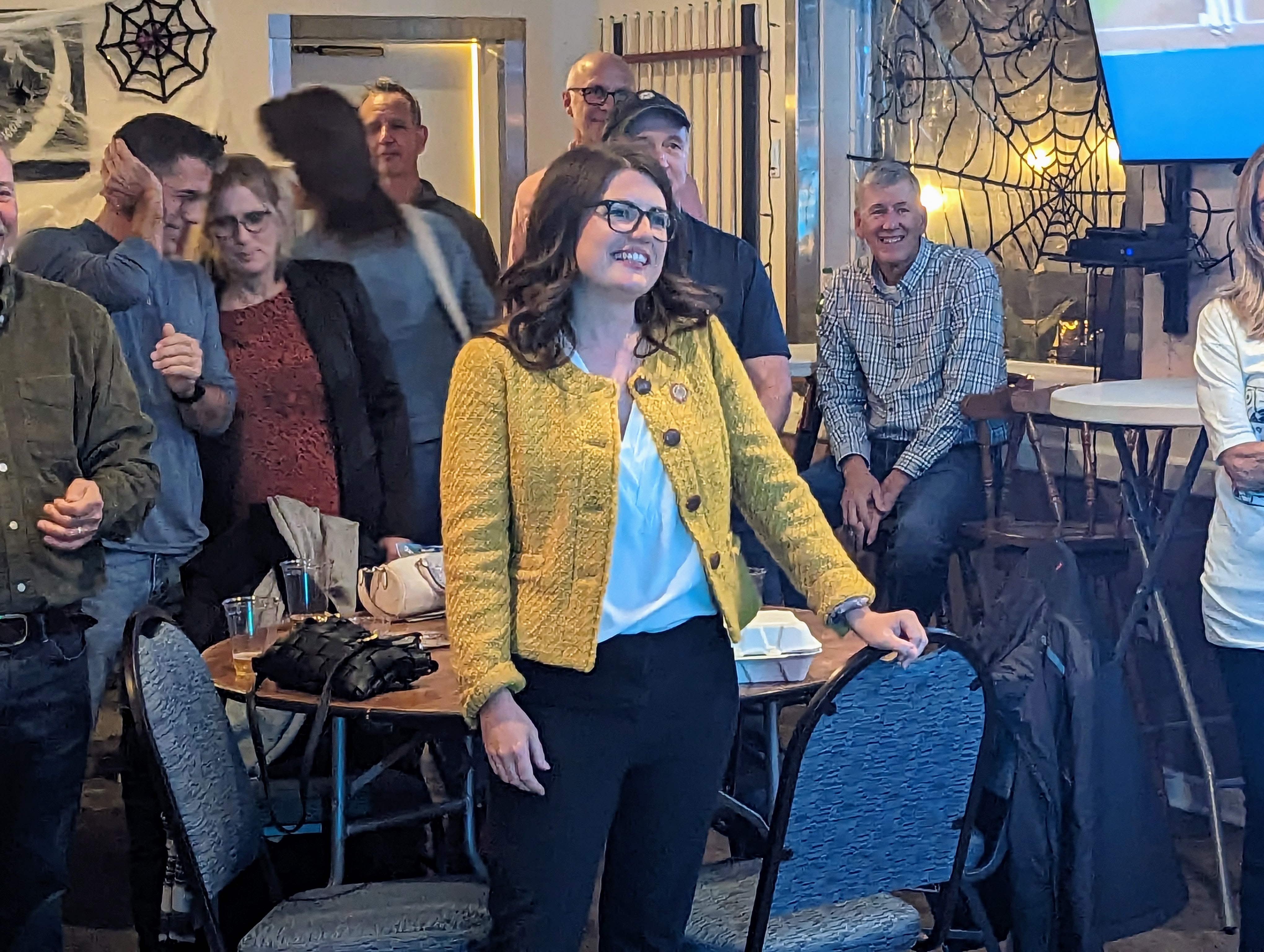 State Sen. Sarah Elfreth listens as the MC at the Eastport Democratic Club tells the crowd she is running for House of Representatives, a day before she officials announced her candidacy.