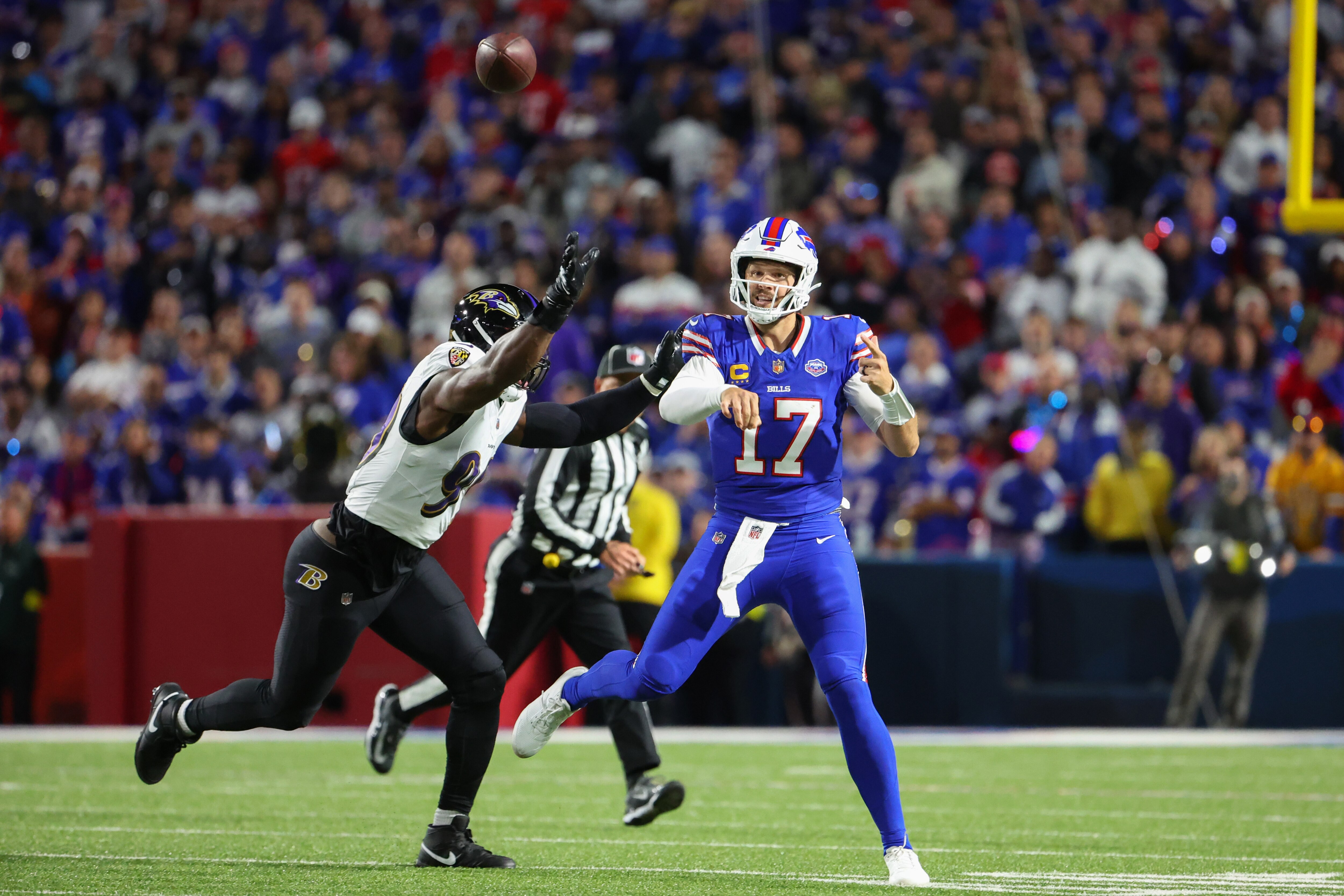 Josh Allen of the Bills, who finished with 394 passing yards, throws under pressure from the Ravens’ Odafe Oweh during the second quarter.
