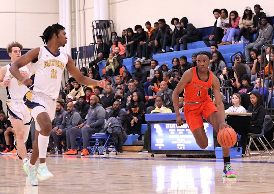 City's Trent Egbiremolen (right) drives toward the basket as Perry Hall's Tryston Ofoh closes in. The fifth-ranked Knights improved to 9-0 with a 90-58 victory over Gators in the final game of the Overlea boys basketball invitational Wednesday evening in Baltimore County.