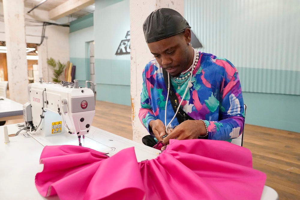 Bishme Cromartie, a contestant on Season 20 of Bravo's “Project Runway,” works on a design during the episode “Project Redemption!” Cromartie won the competition in an episode that aired Thursday.